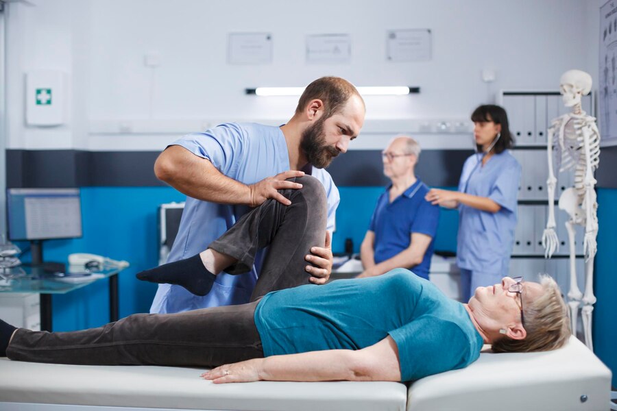 A physicin helping the women in her exercise.