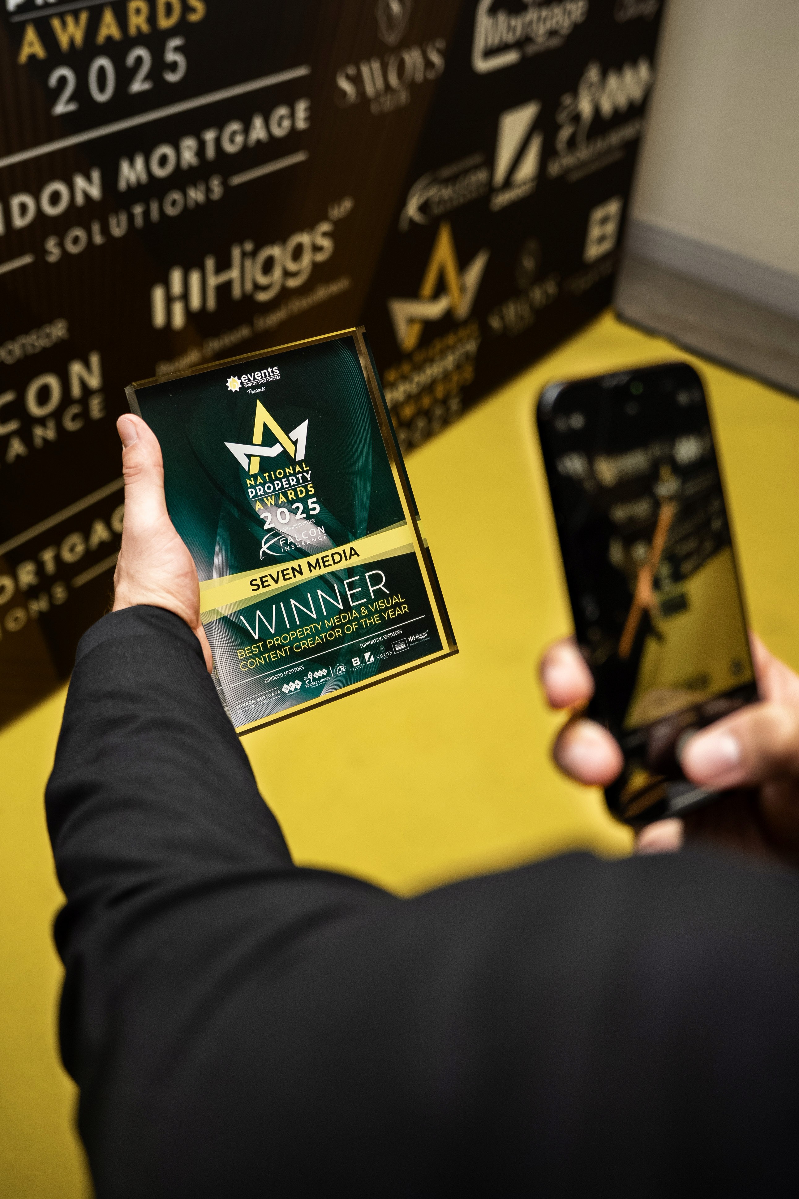 Woman in conical hat rides bicycle down street.