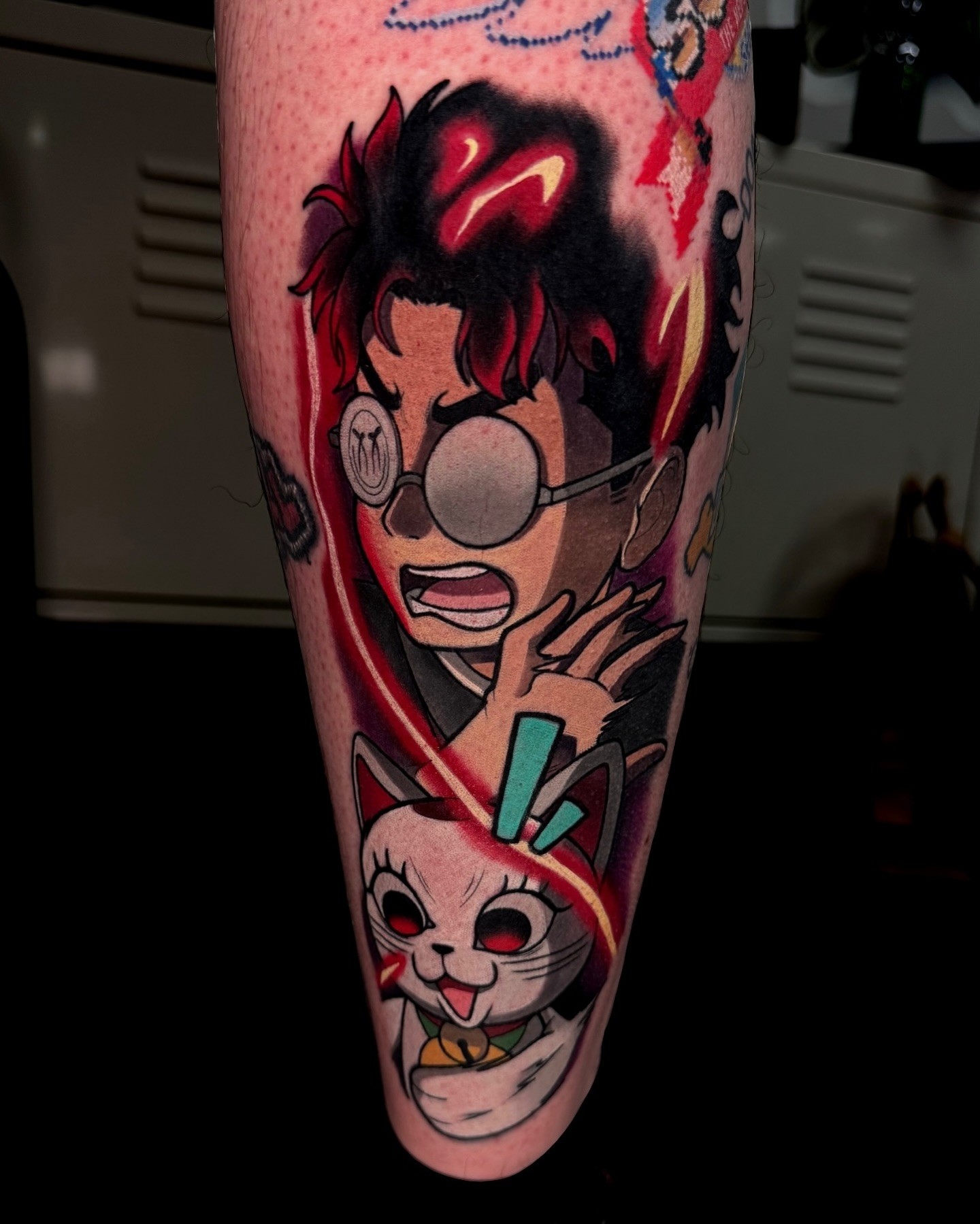 Siitattooist brings Dandadan's quirky humor to life in this colorful tattoo featuring Okarun's shocked expression alongside the mischievous Turbo Granny. The use of bold colors and dynamic linework adds a sense of movement, while the red and white tones of Turbo Granny pop against the dark-haired Okarun. This piece perfectly encapsulates the show's unique blend of action and comedy, making it an eye-catching tribute to its offbeat charm.