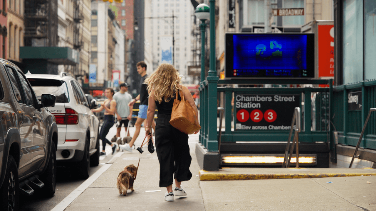 Street scene with people walking and buildings in the background