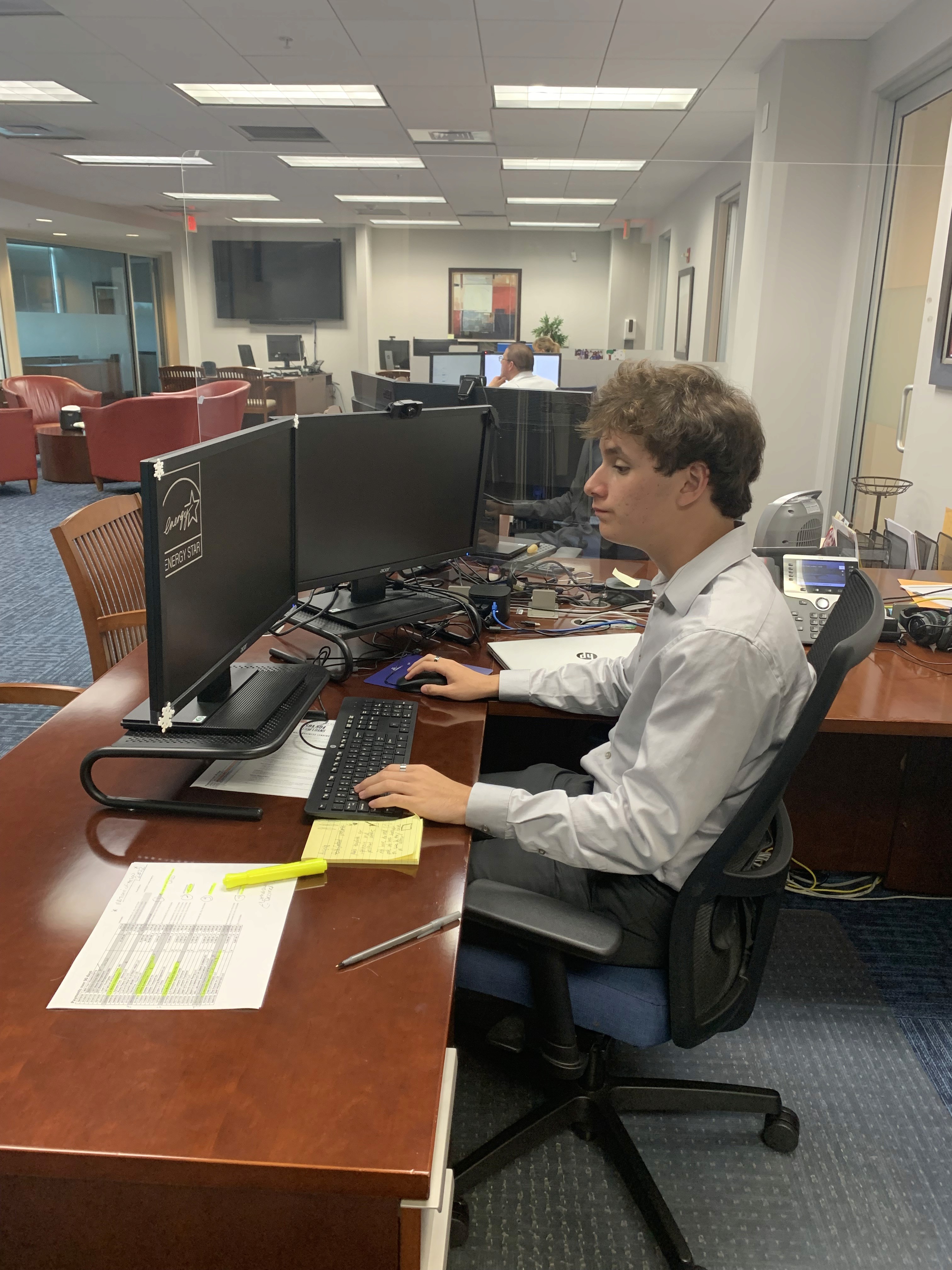 John Doe working on his computer in the office