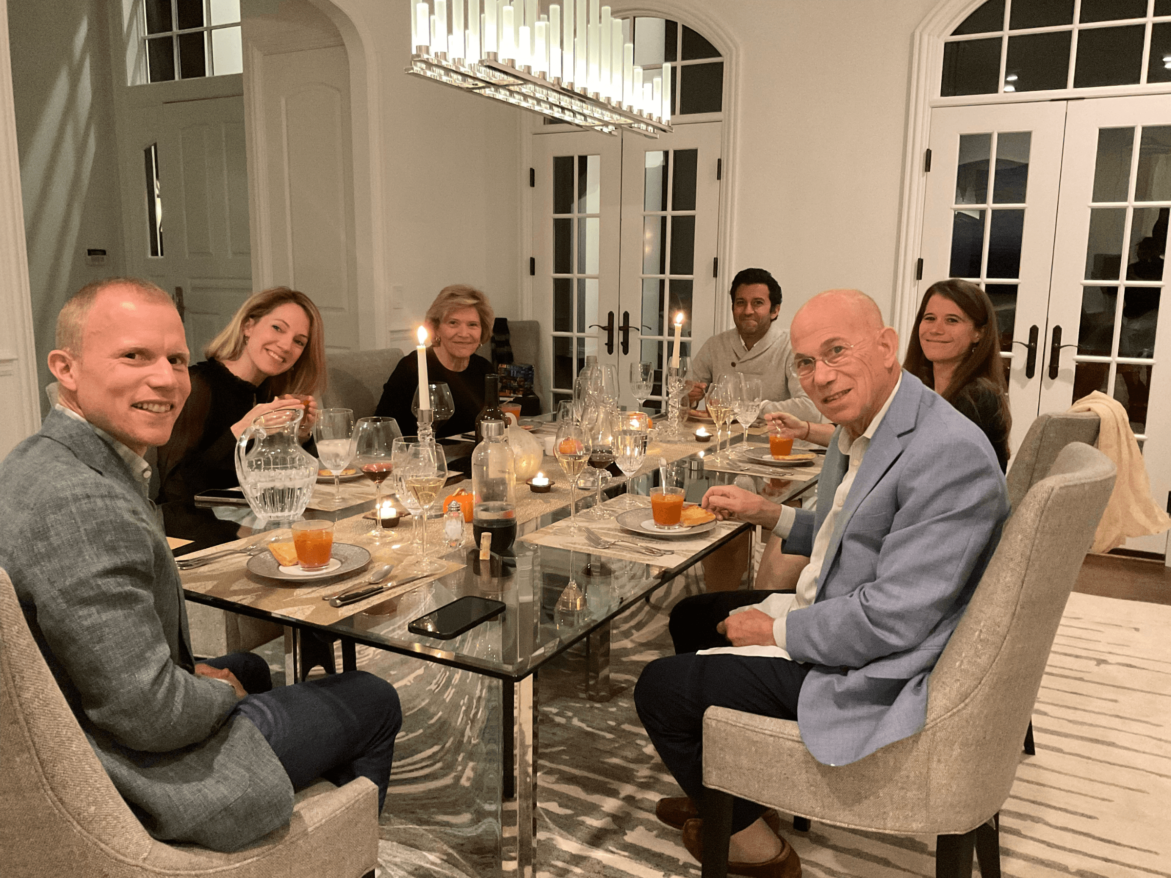 Freshly baked Margherita pizza with melted cheese, tomato sauce, and basil leaves, held by a person’s hand.