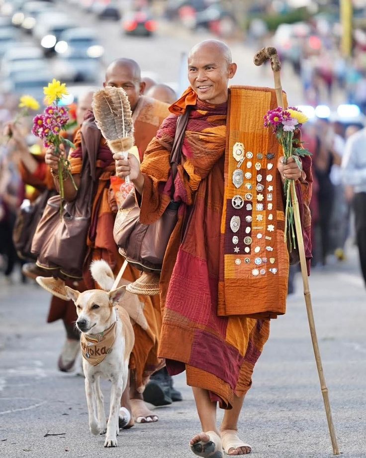 A man playing a drum in front of a group of people