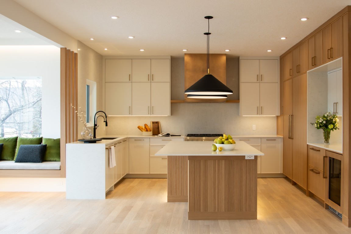 Image of Modern kitchen interior with island, cabinets, and pendant lighting, designed by KHD Homes for luxury homes.