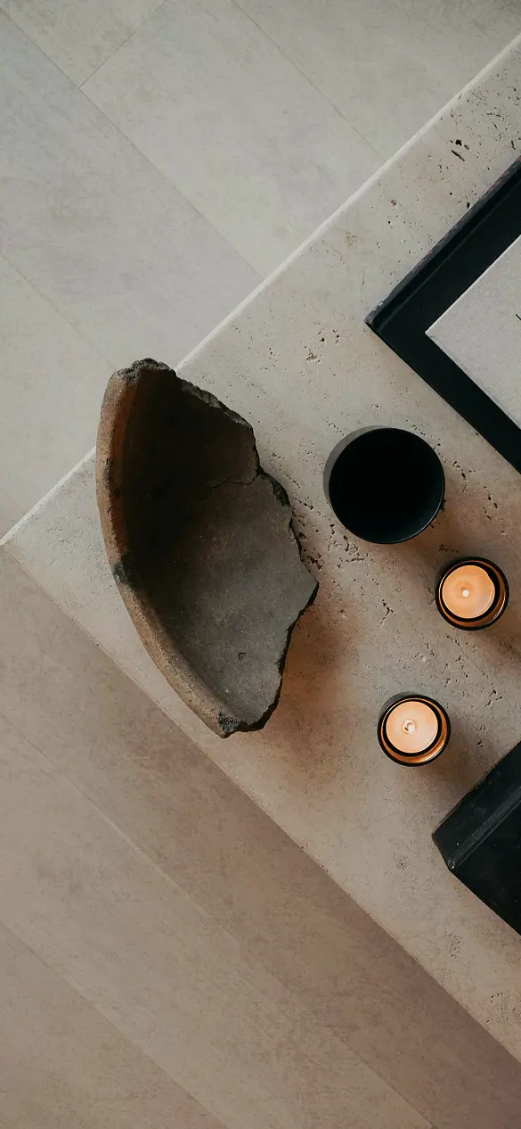 Luxurious spa setting featuring glowing candles on a textured stone surface, embodying wellness and premium fitness recovery.