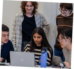 A young woman smiles in a subway station, while two others stand in the background, creating a dynamic urban scene.