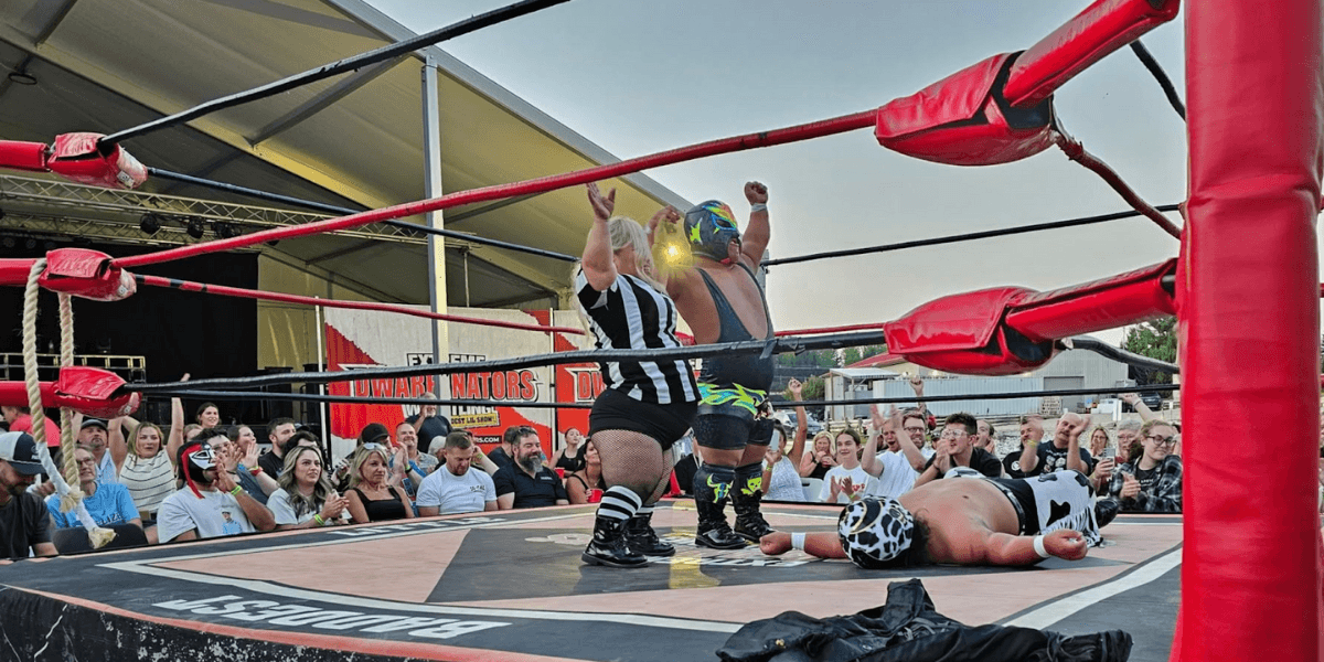 A victorious moment in Dwarfanators wrestling, showcasing athleticism, defying size expectations, and providing thrilling entertainment to diverse audiences.