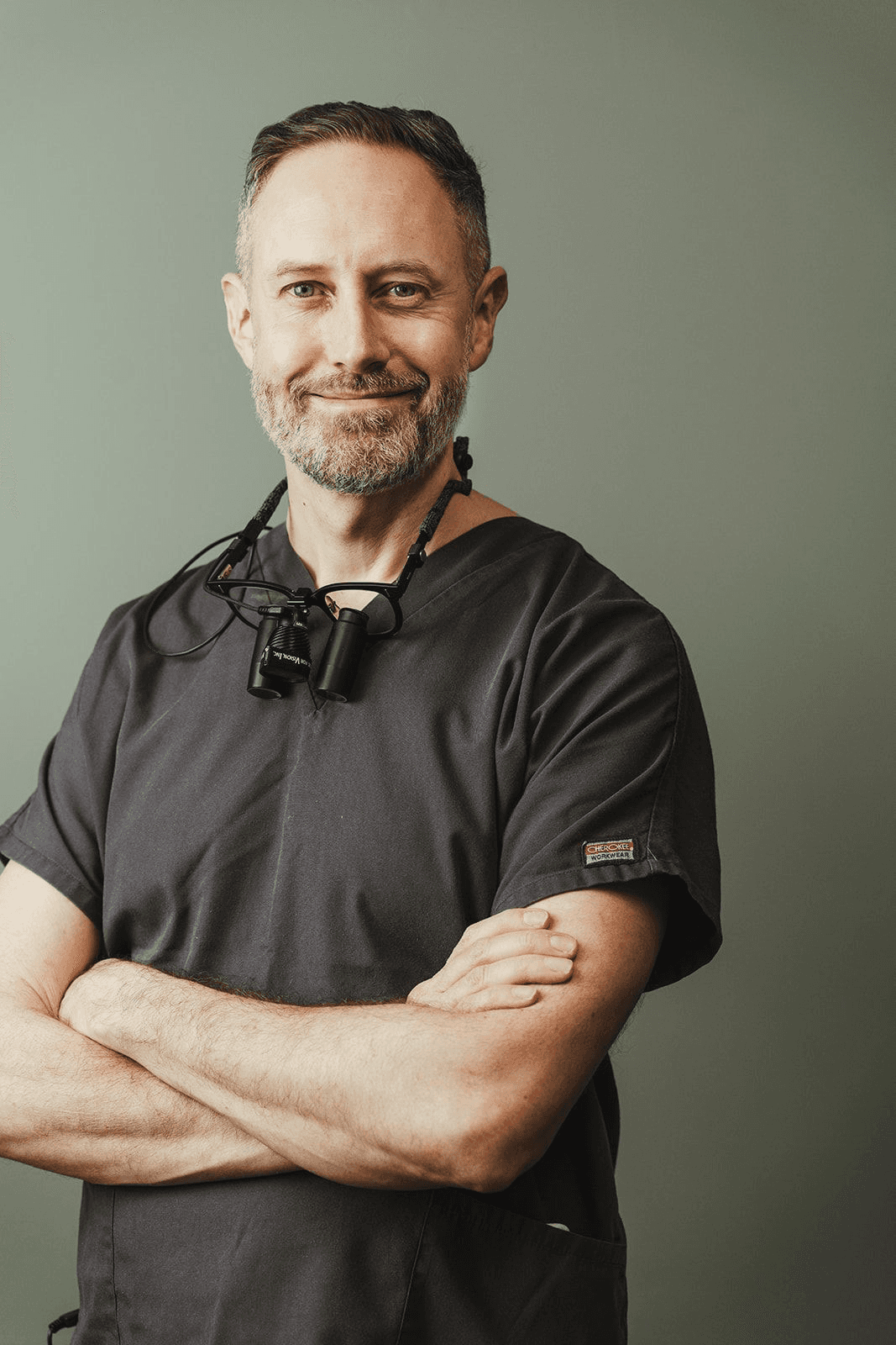 person in black leather shoes standing on yellow leaves