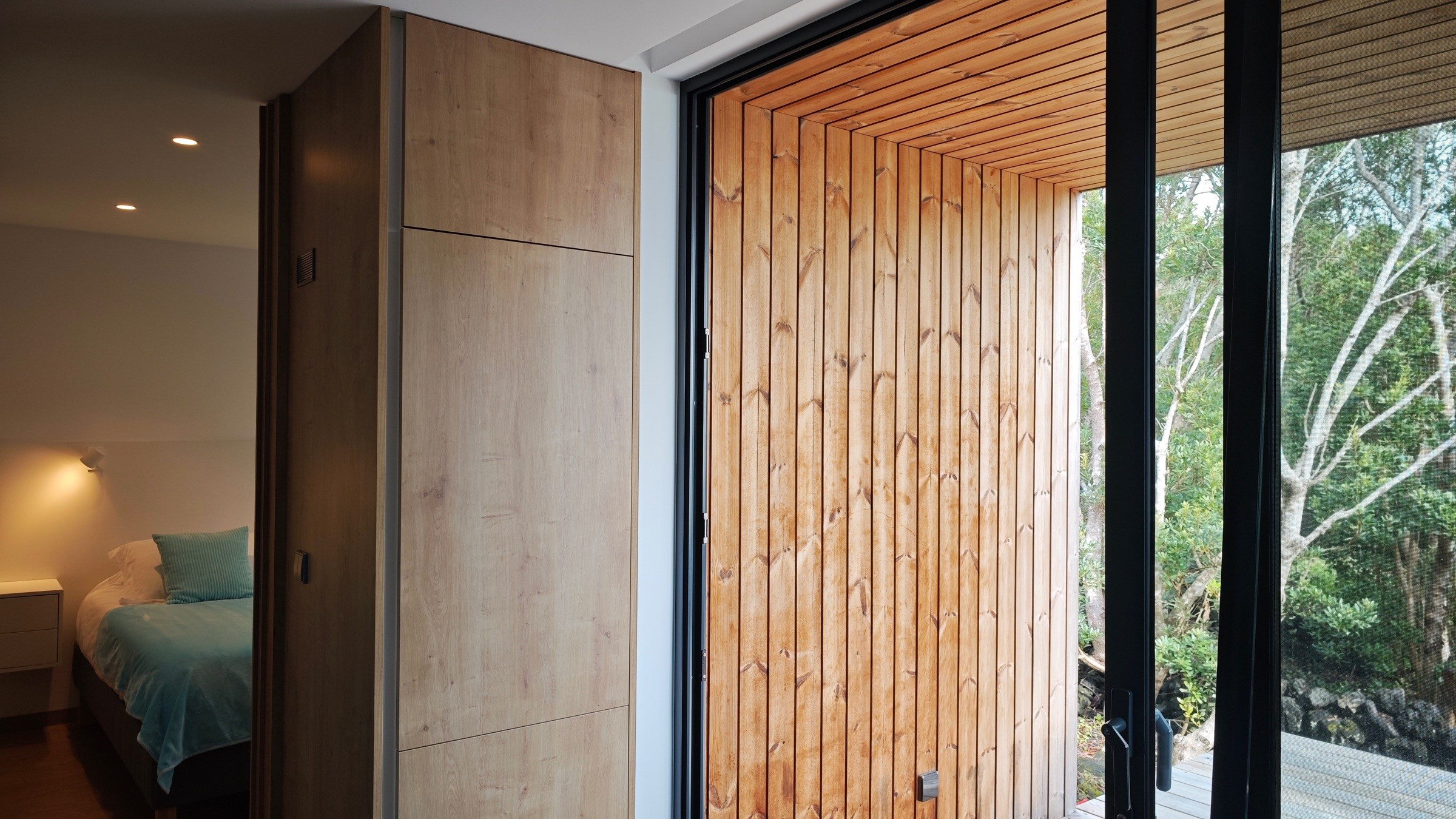 Interior view showing the living room connected to the bedroom and opening to the outdoor deck