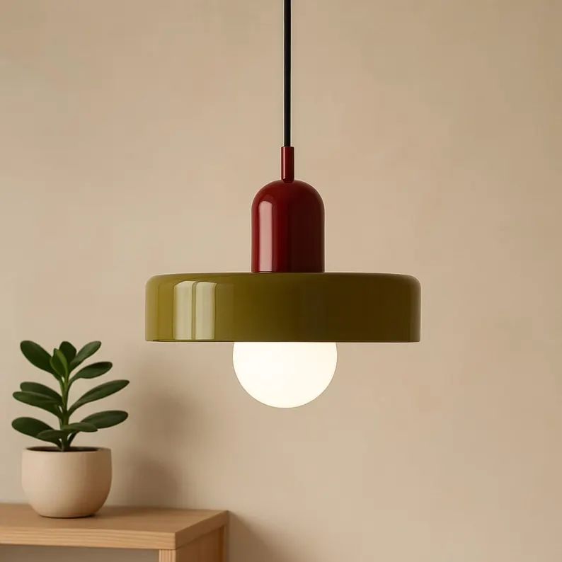 Electrician on ladder wiring modern multi-arm ceiling light fixture during home installation