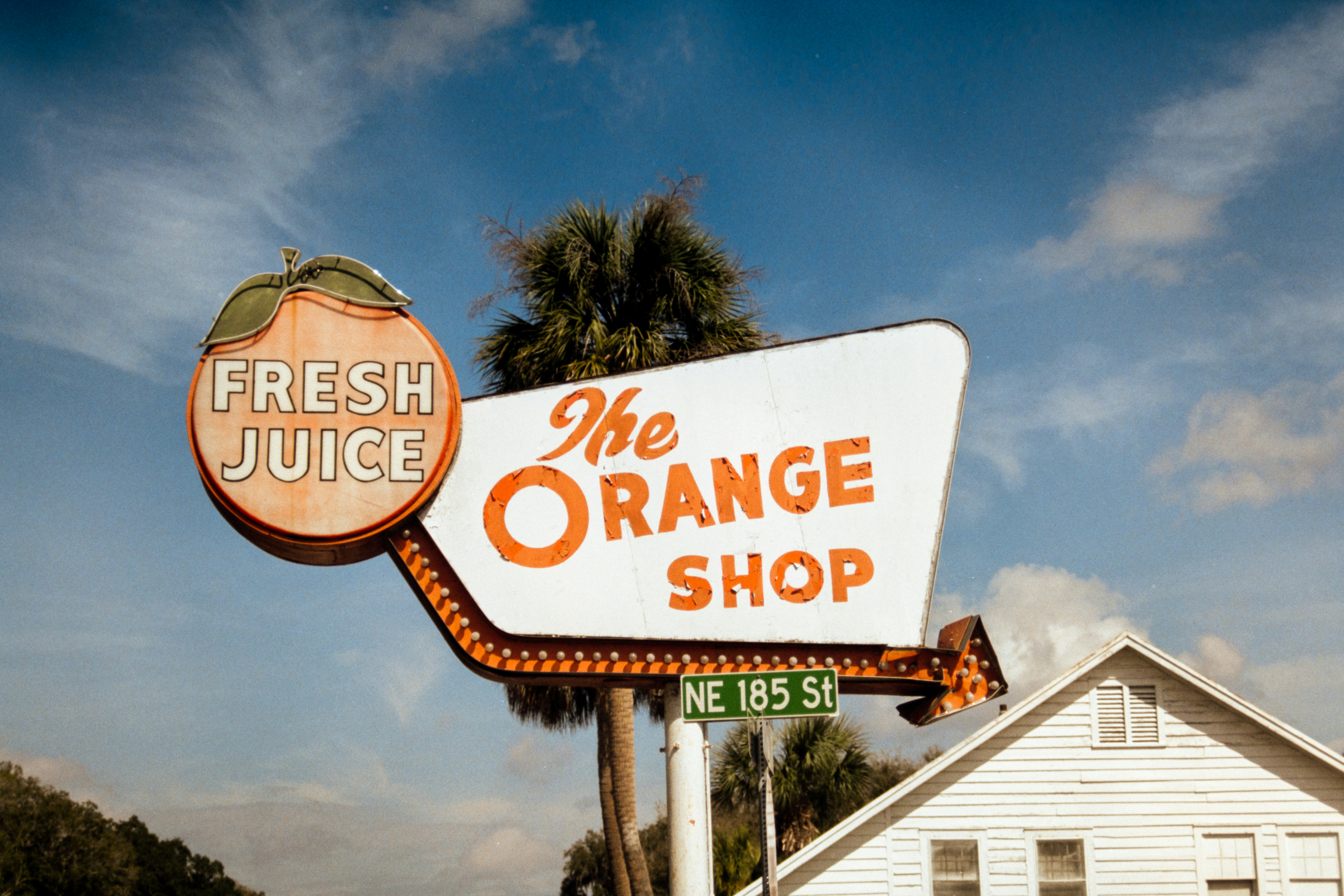 Retro orange shop sign advertising fresh juice.