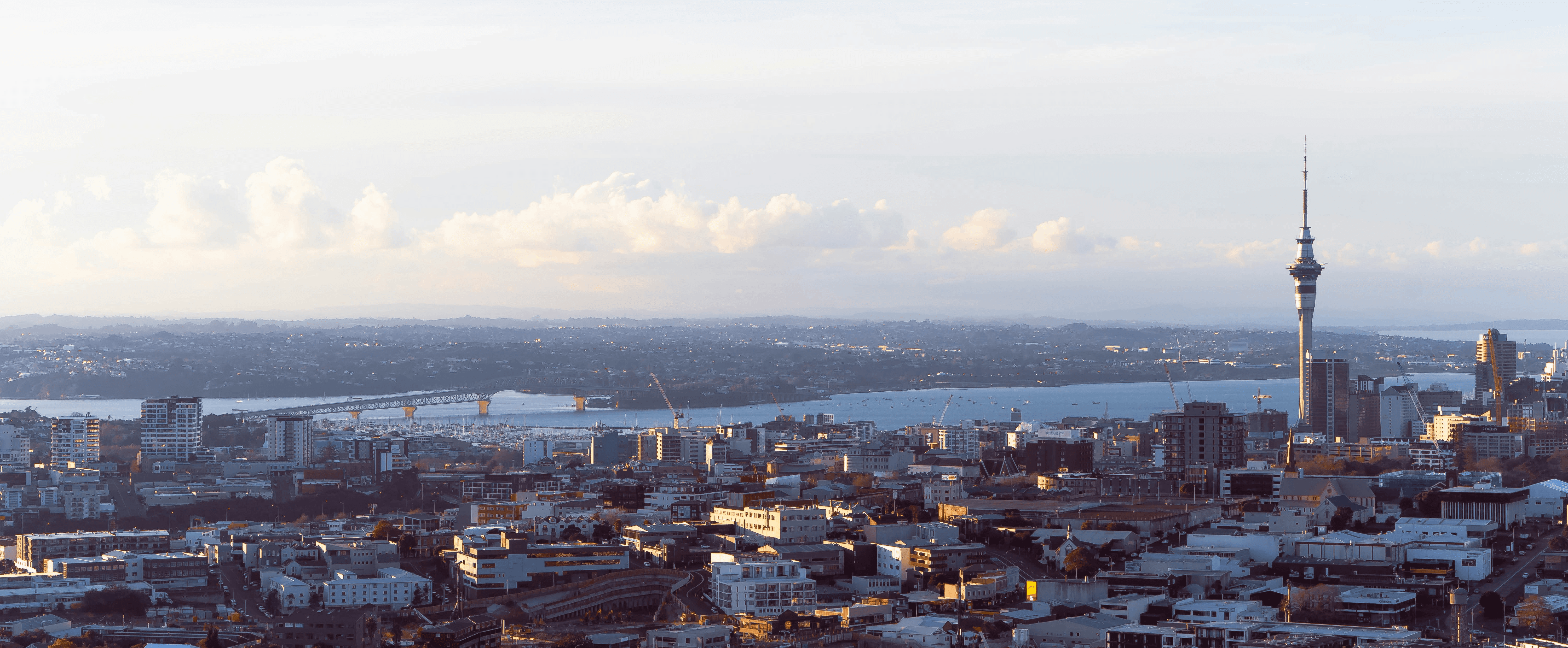 city skyline under white clouds during daytime
