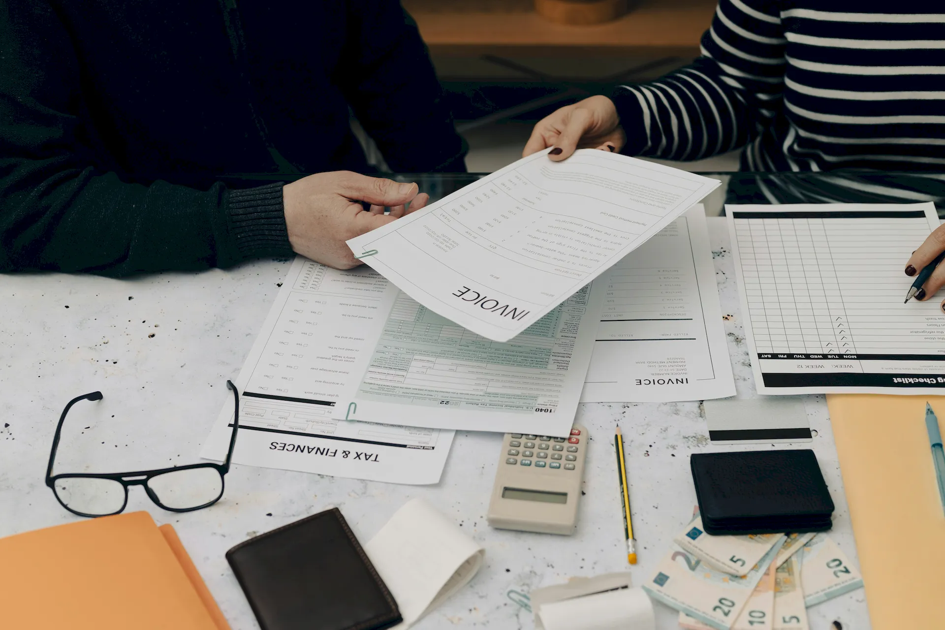 People sitting a a table going over financial statements