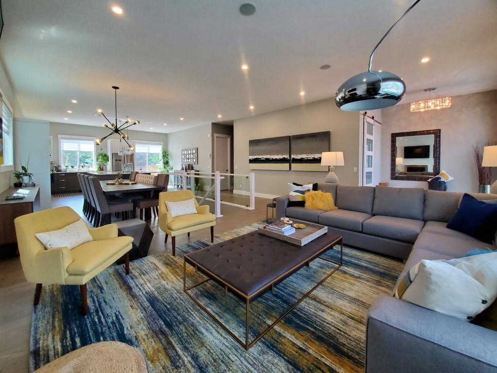 Image of Luxurious living room with sofa, chairs, coffee table, and pendant lighting, KHD Homes design-build interior.