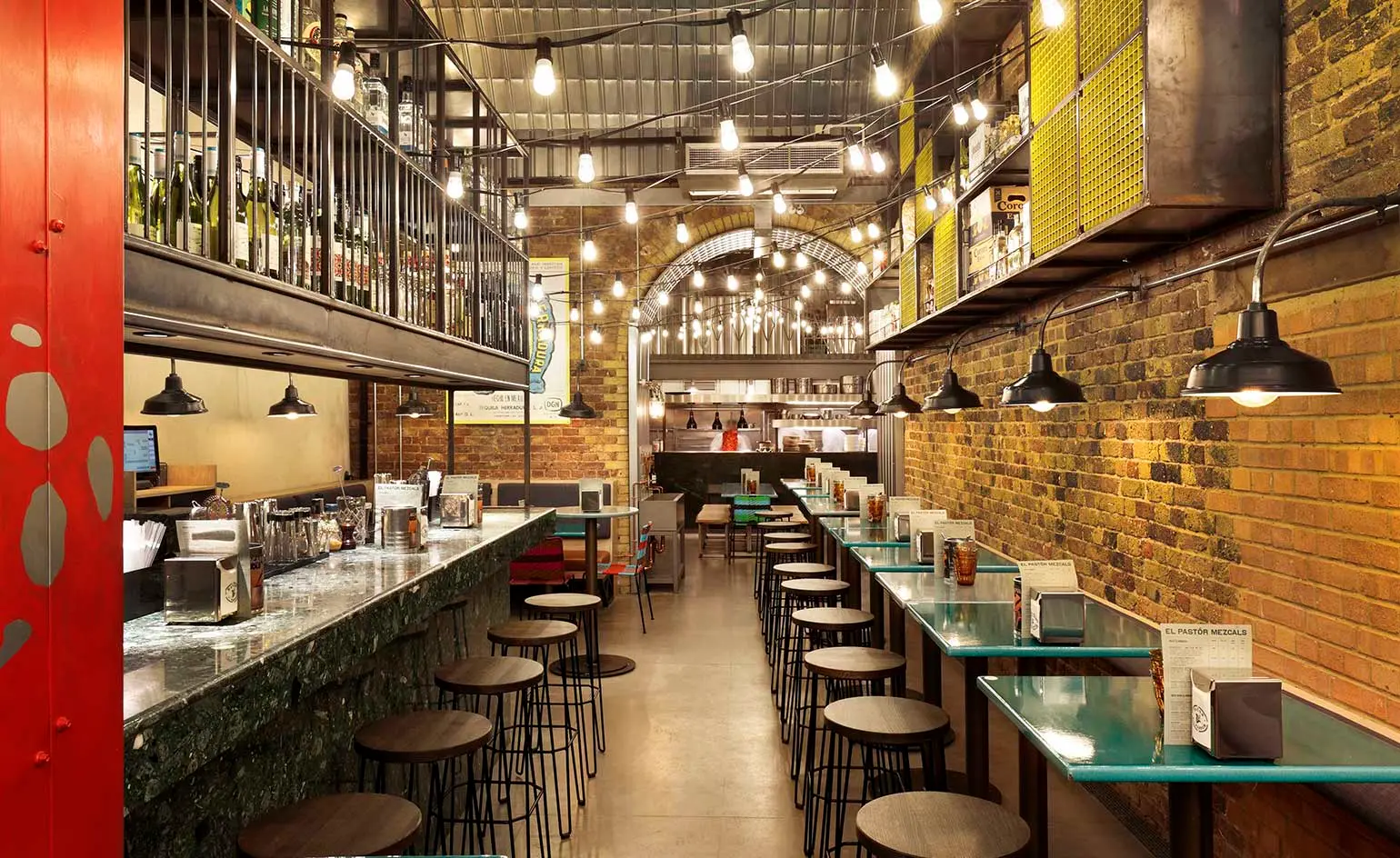 El Pastor restaurant near London Bridge with exposed brick walls and bar seating, open for lunch and tacos.