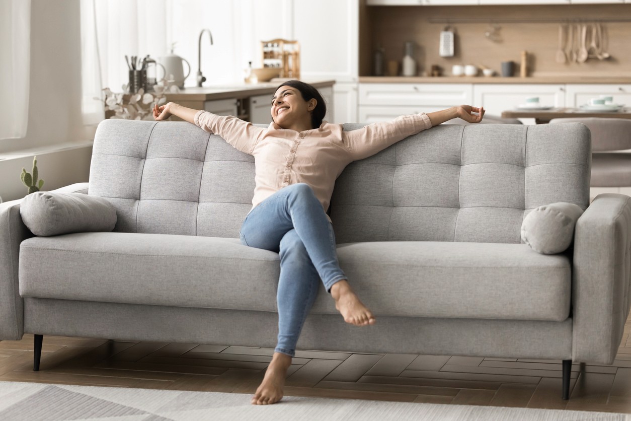 Women relaxing on couch after installing a water heater