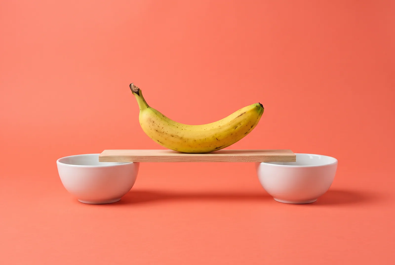 A banana crossing a small wooden plank between two fruit bowls, switching from BrainBuddy
