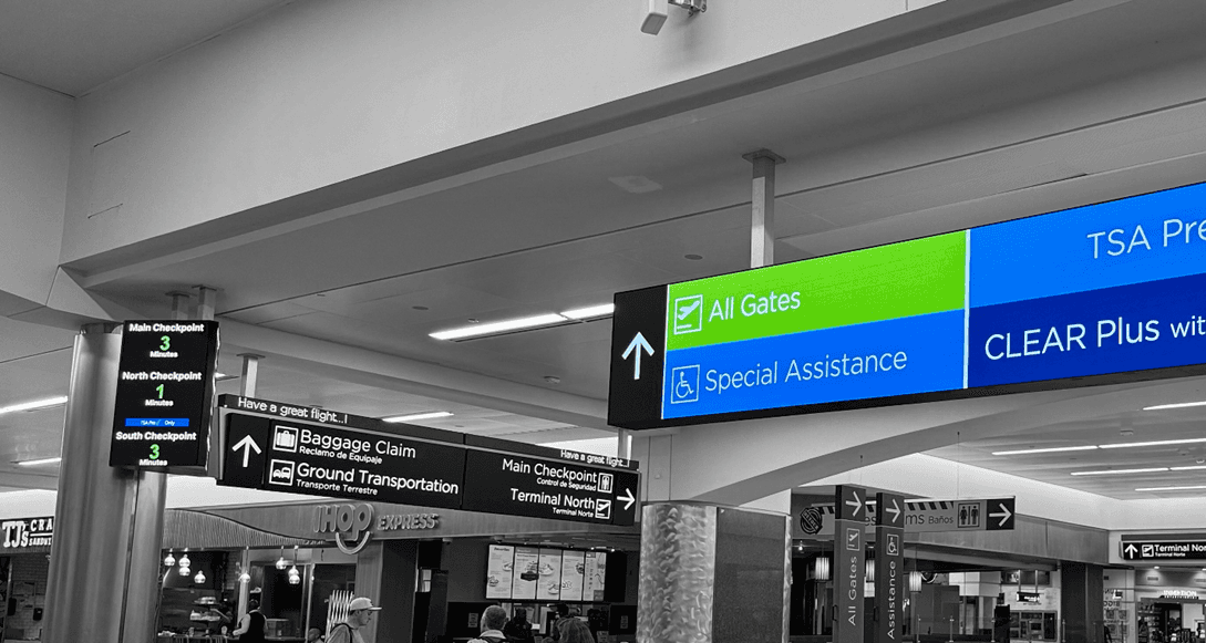 A photo of multiple digital signs in an airport