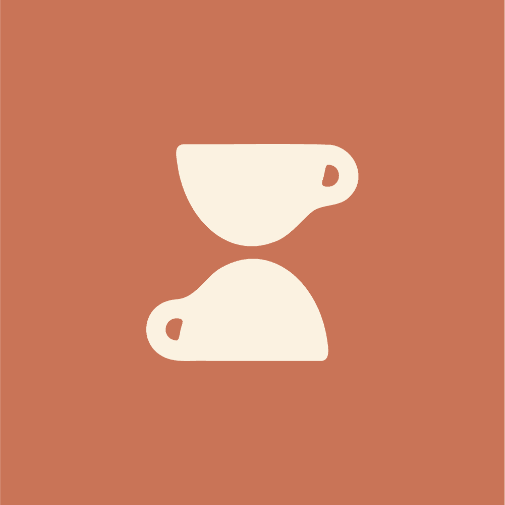 Modern home office setup with a monitor, ergonomic chair, keyboard, and indoor plants near a window with blinds.