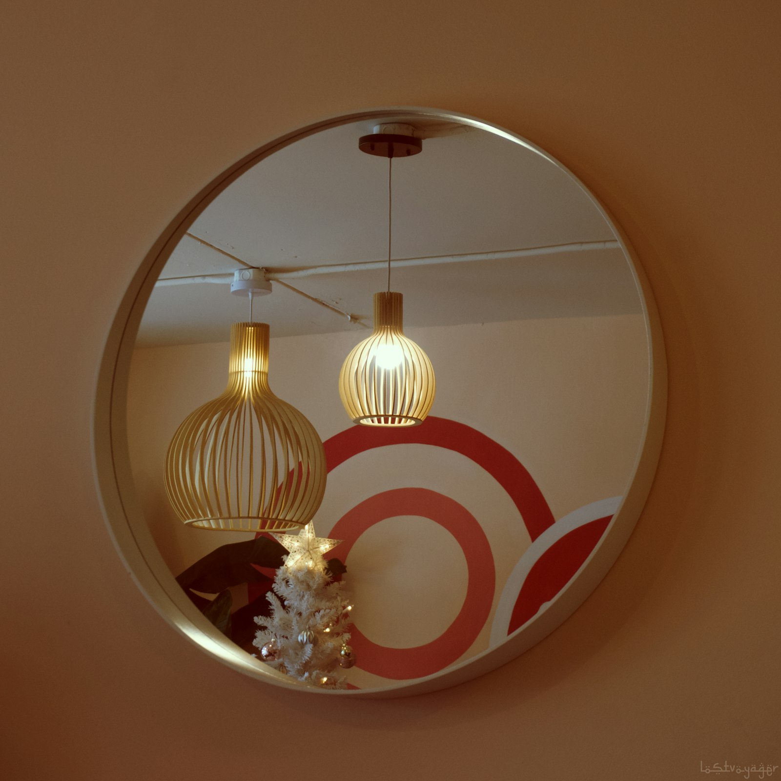 Pendant lights reflected in a round mirror