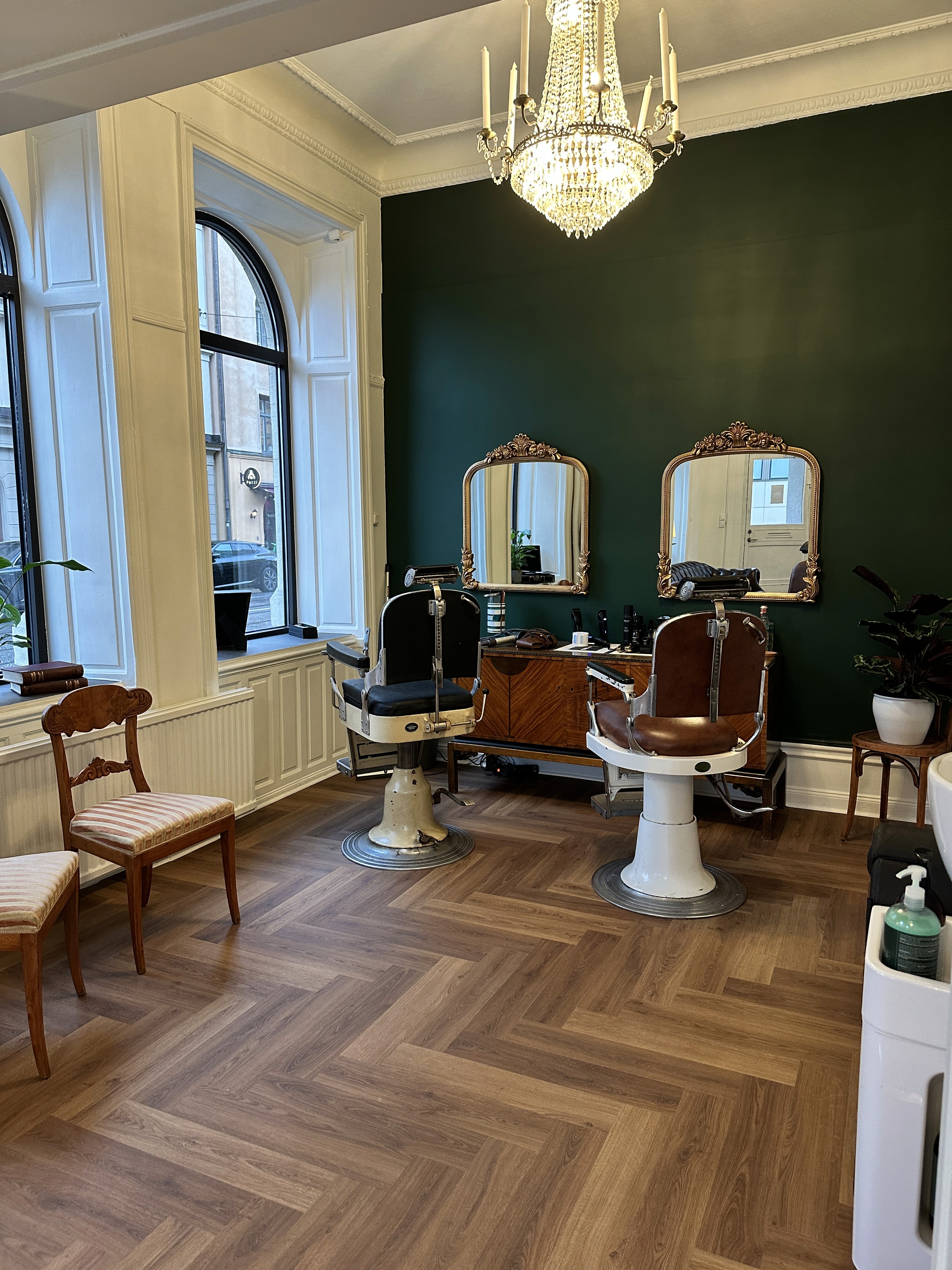 Barber styling a red-bearded man's hair