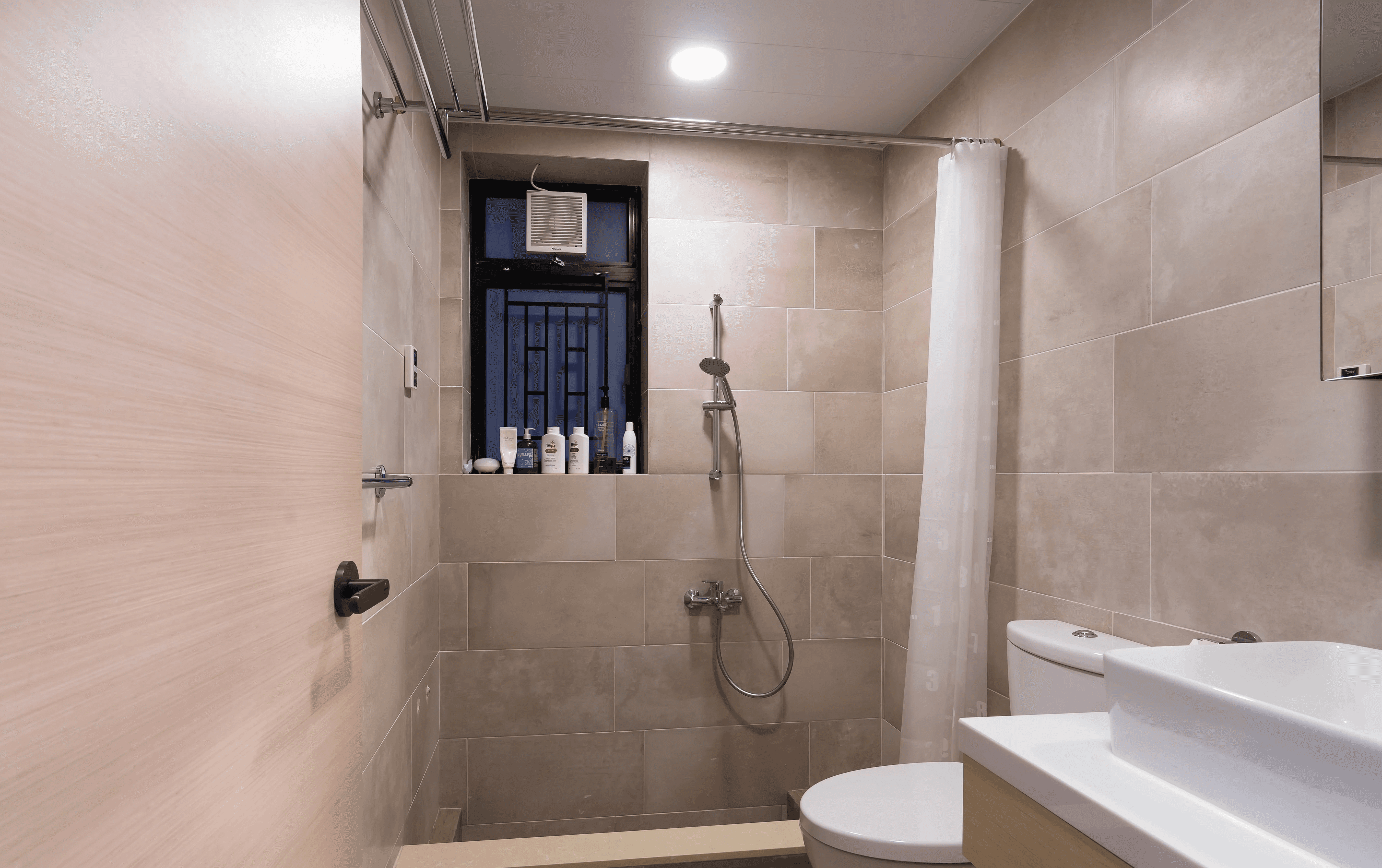 Achieving a bathroom design simple yet functional, this Castello layout positions a walk-in shower behind a translucent curtain to maximize open floor space.