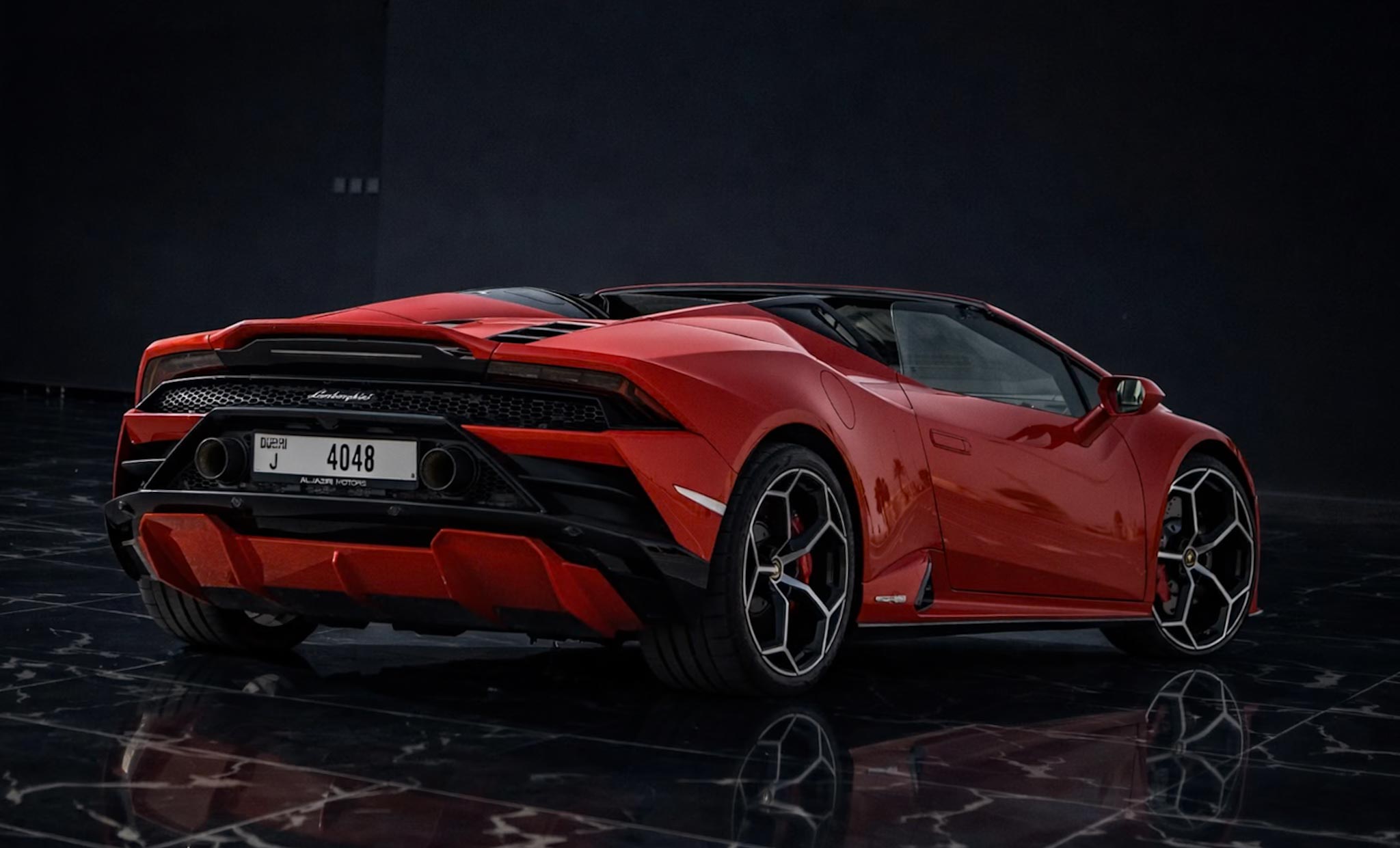 Rear view of Lamborghini Huracán EVO Spyder RWD with aggressive exhaust and open-top design