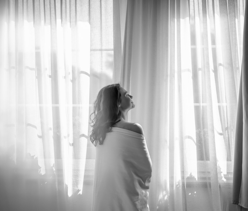 Autumn trees line a winding country road from above.