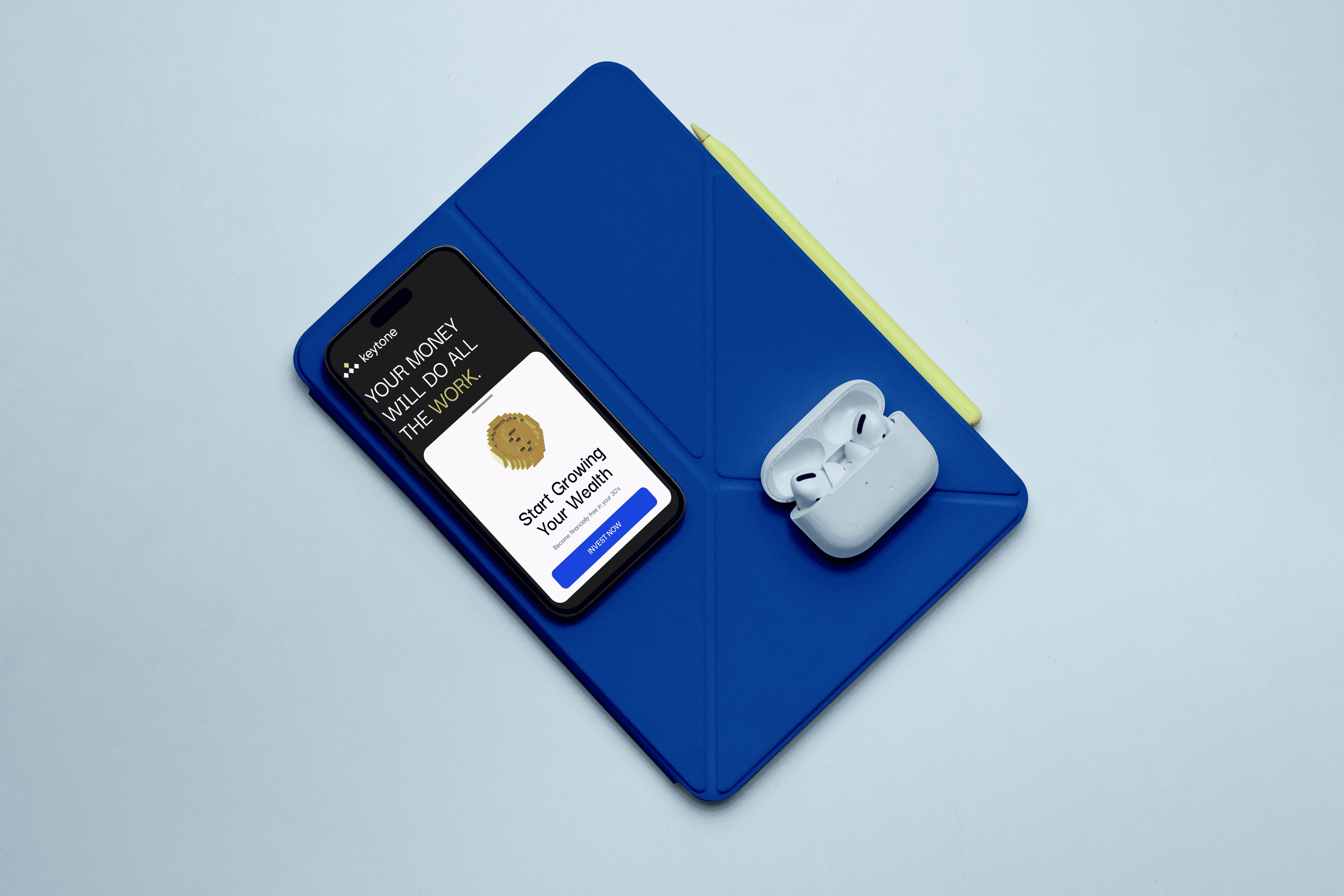 Blue tablet cover with stylus, smartphone displaying financial app, and open wireless earbuds case on a light background.