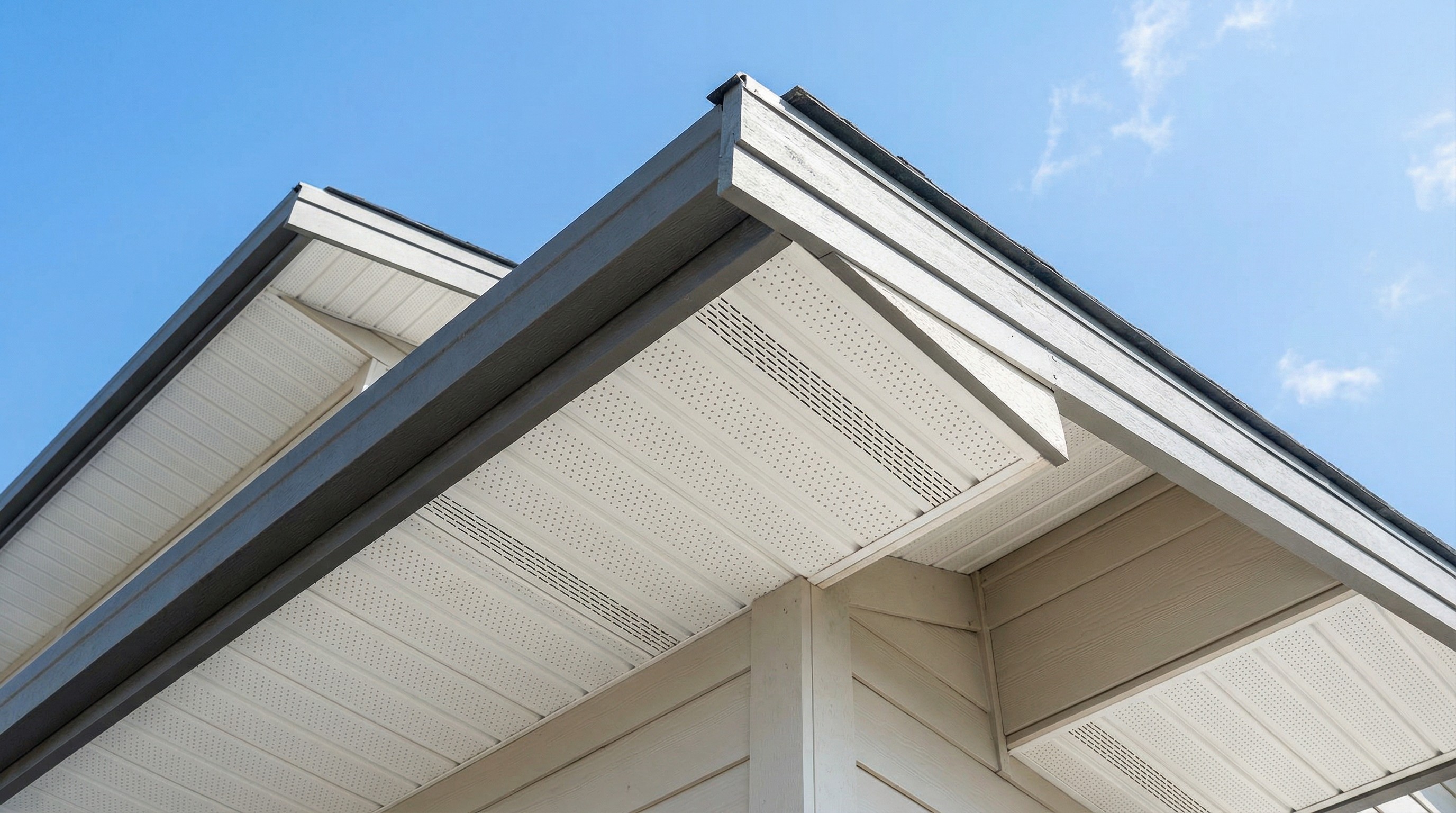 Close-up view of house roof with modern design and clear sky background.