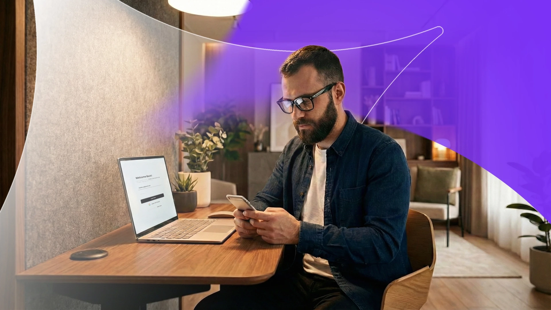 A man using a smartphone for multi-factor authentication while working on a laptop, illustrating the identity security gap for MSPs.