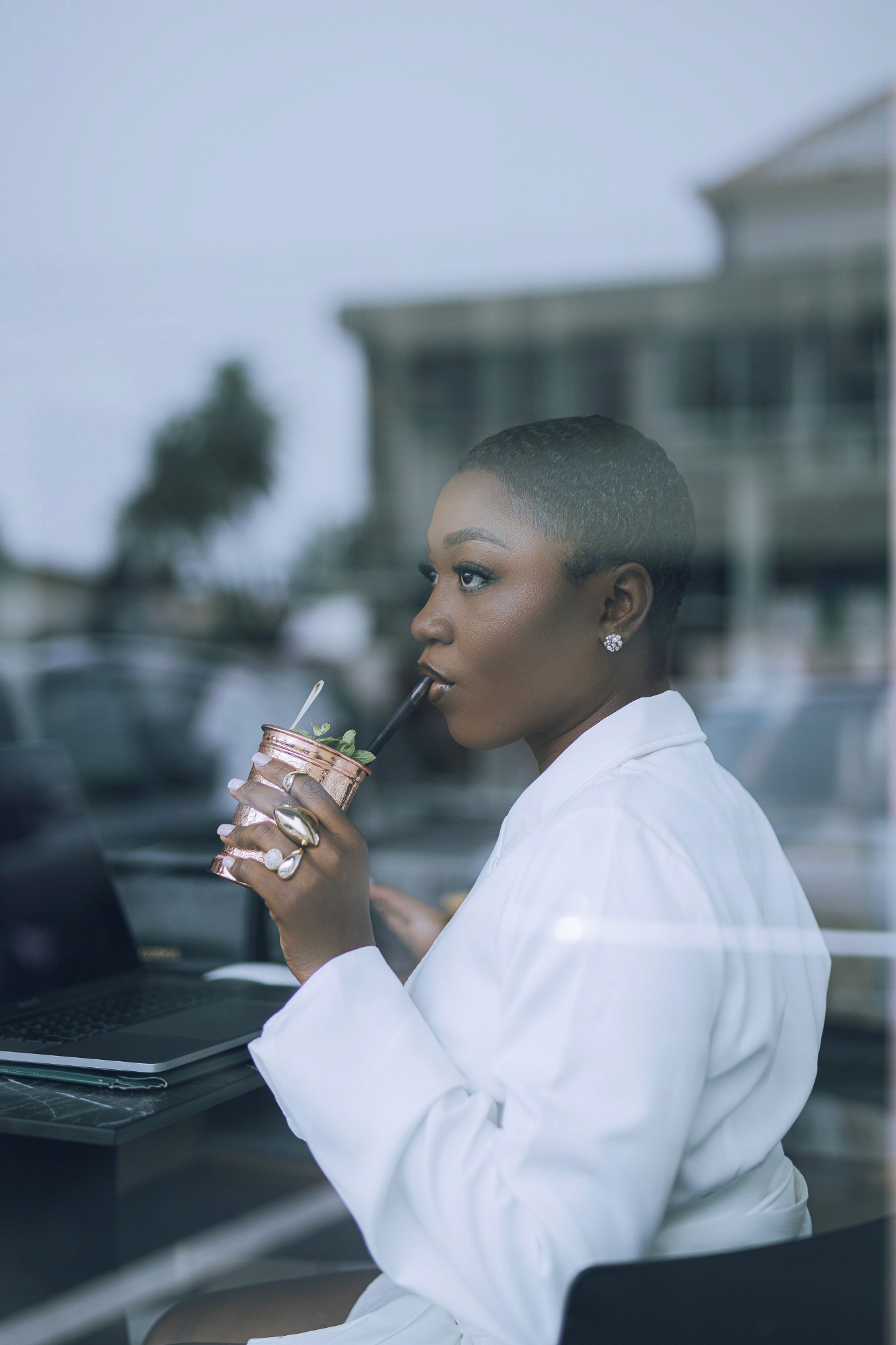 A woman enjoying a quiet drink beside a window