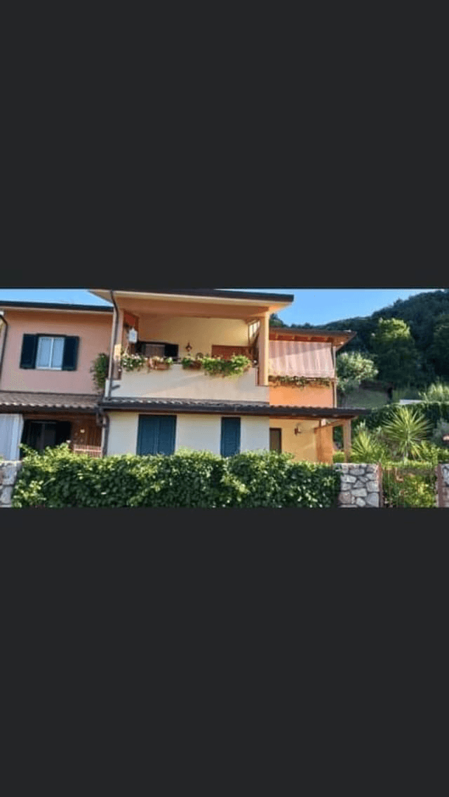 A modern brick house with a two-car garage, well-manicured lawn, and clear blue sky in the background.