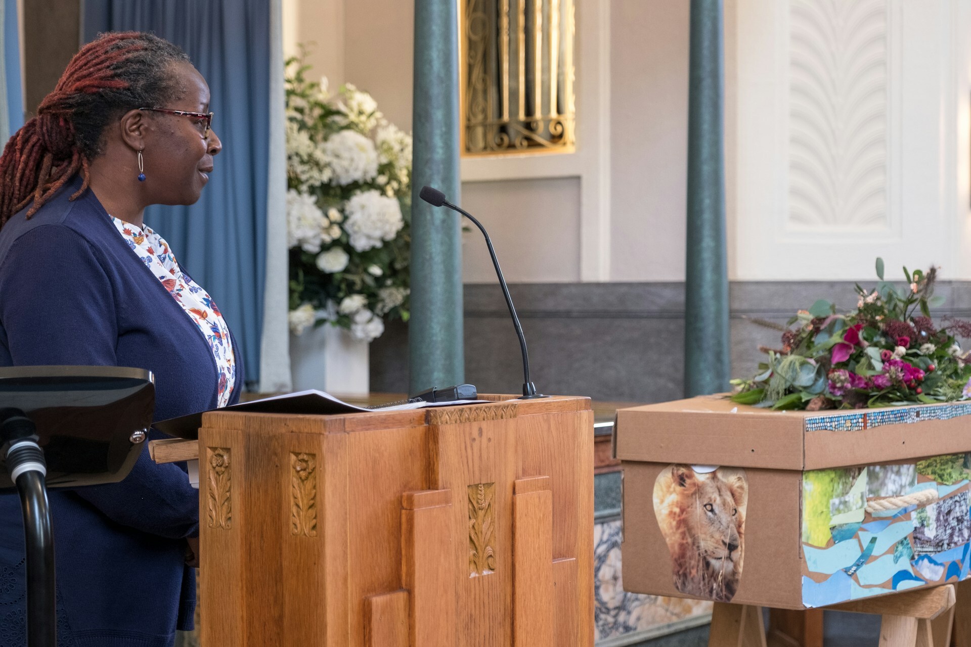 a funeral celebrant with casket