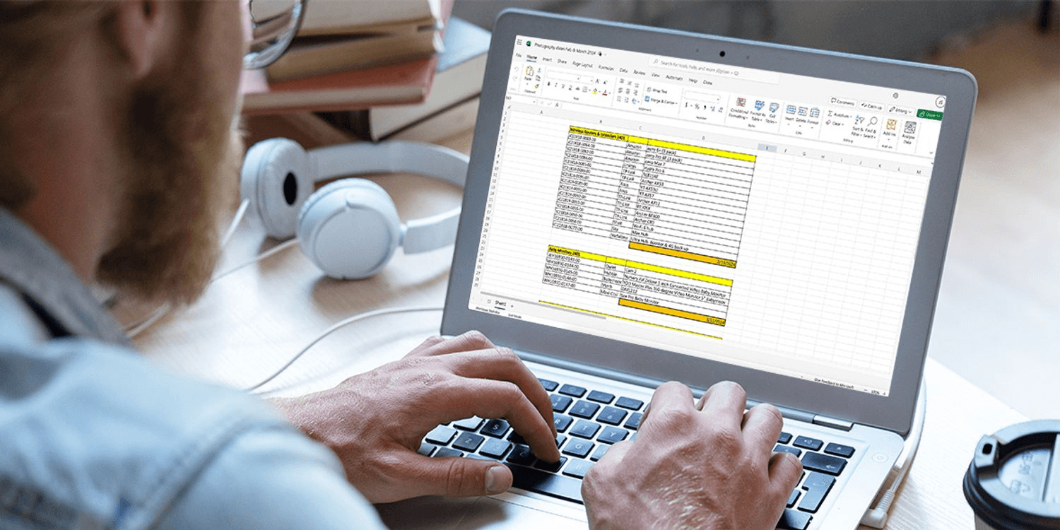 Man typing data into a spreadsheet - How to Use Power Automate in Excel