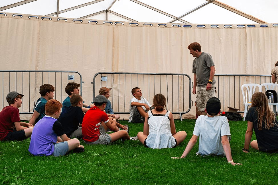 Young people listening at a Frow Show outreach workshop in a marquee