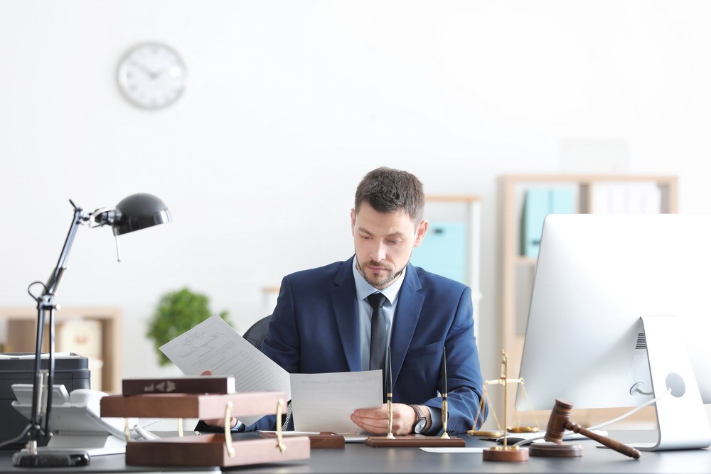 Young male notary working in office