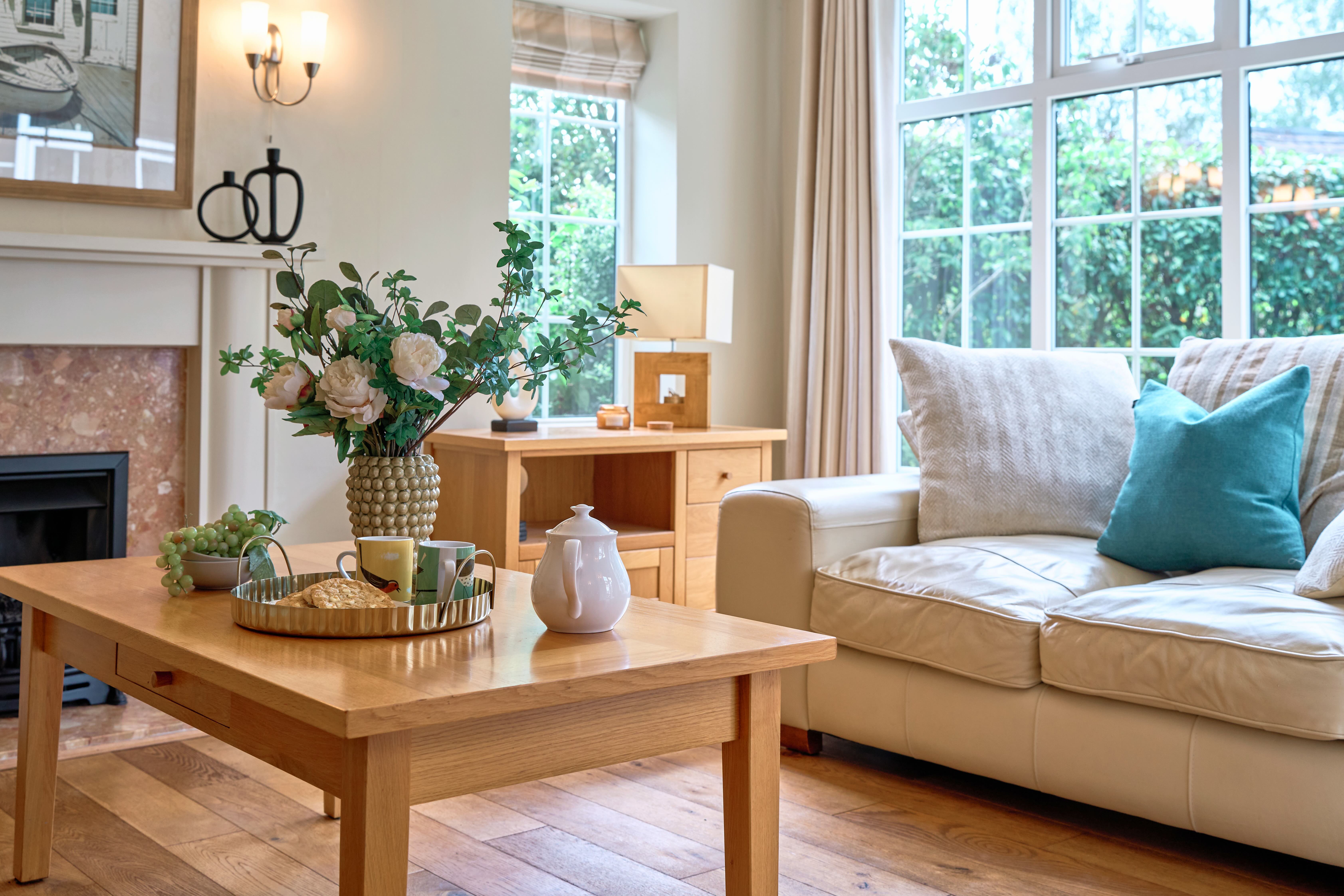 A photograph of a coffee table set with tea and biscuits.