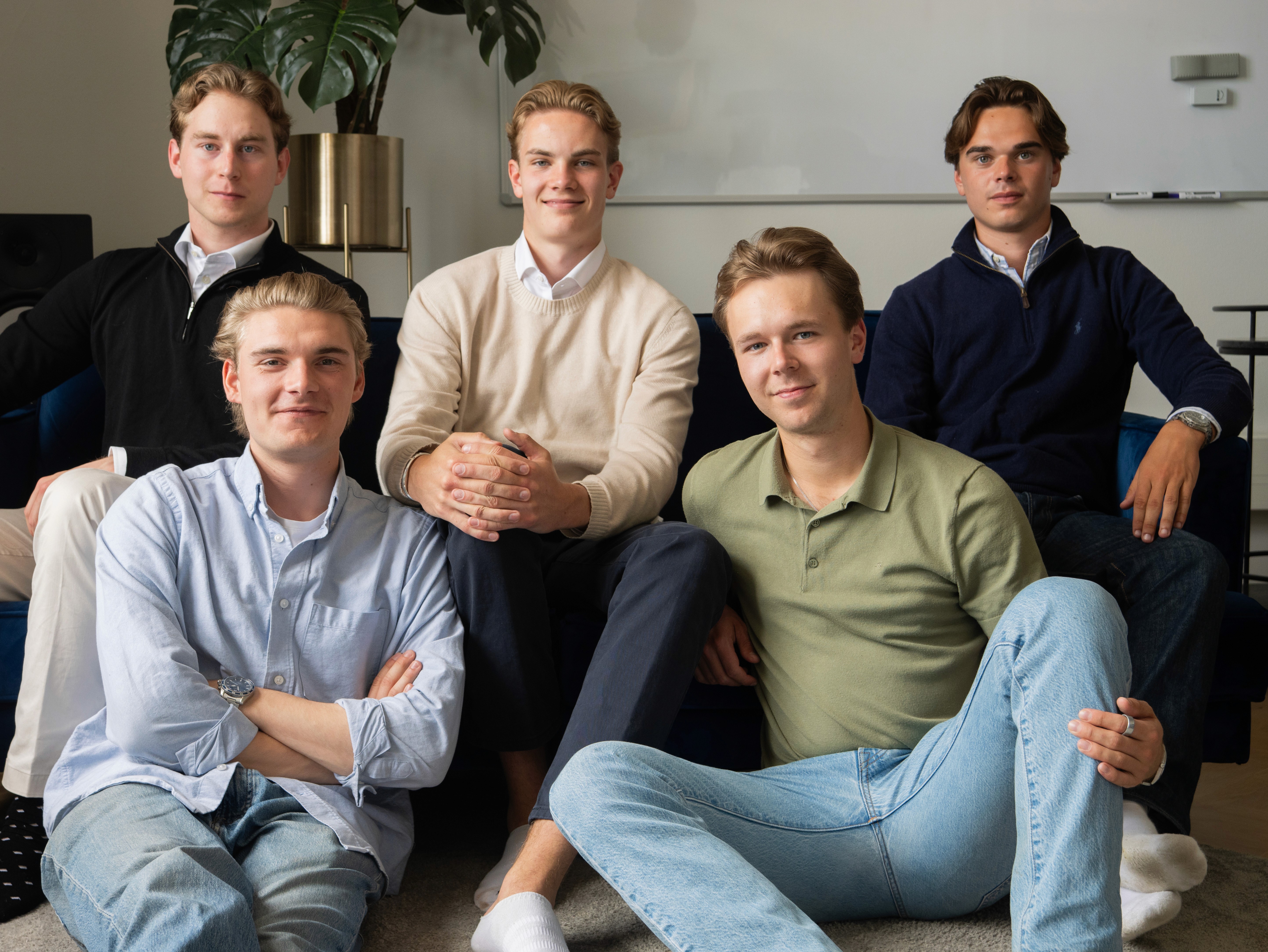 Group of young professionals on couch and floor
