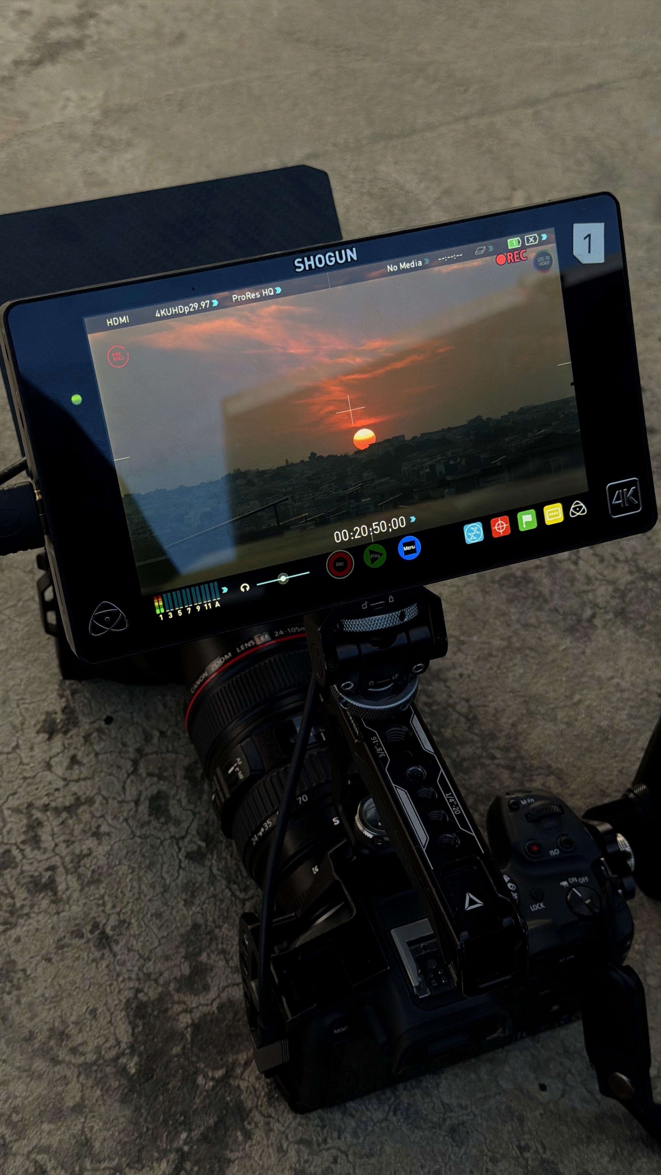 Silhouette of a camera operator filming on a professional set, surrounded by bright studio lights. The scene conveys focus and creative energy.