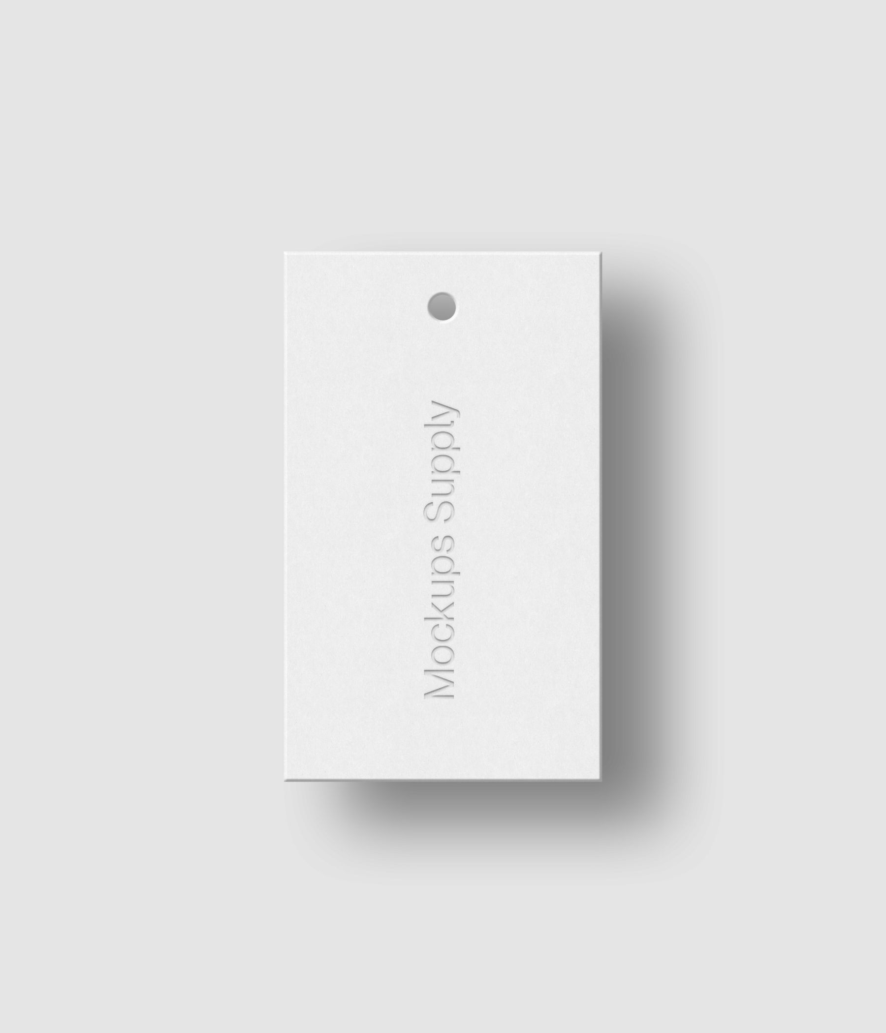 White 3x5 clothing hang tag mockup on white background with debossed logo effect and soft shadow for Photoshop download psd