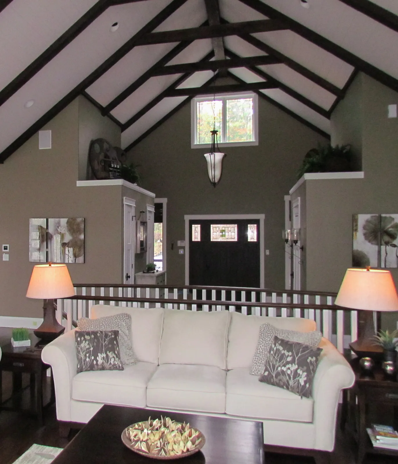 High-end cottage home with high vaulted ceilings and exposed dark beams.
