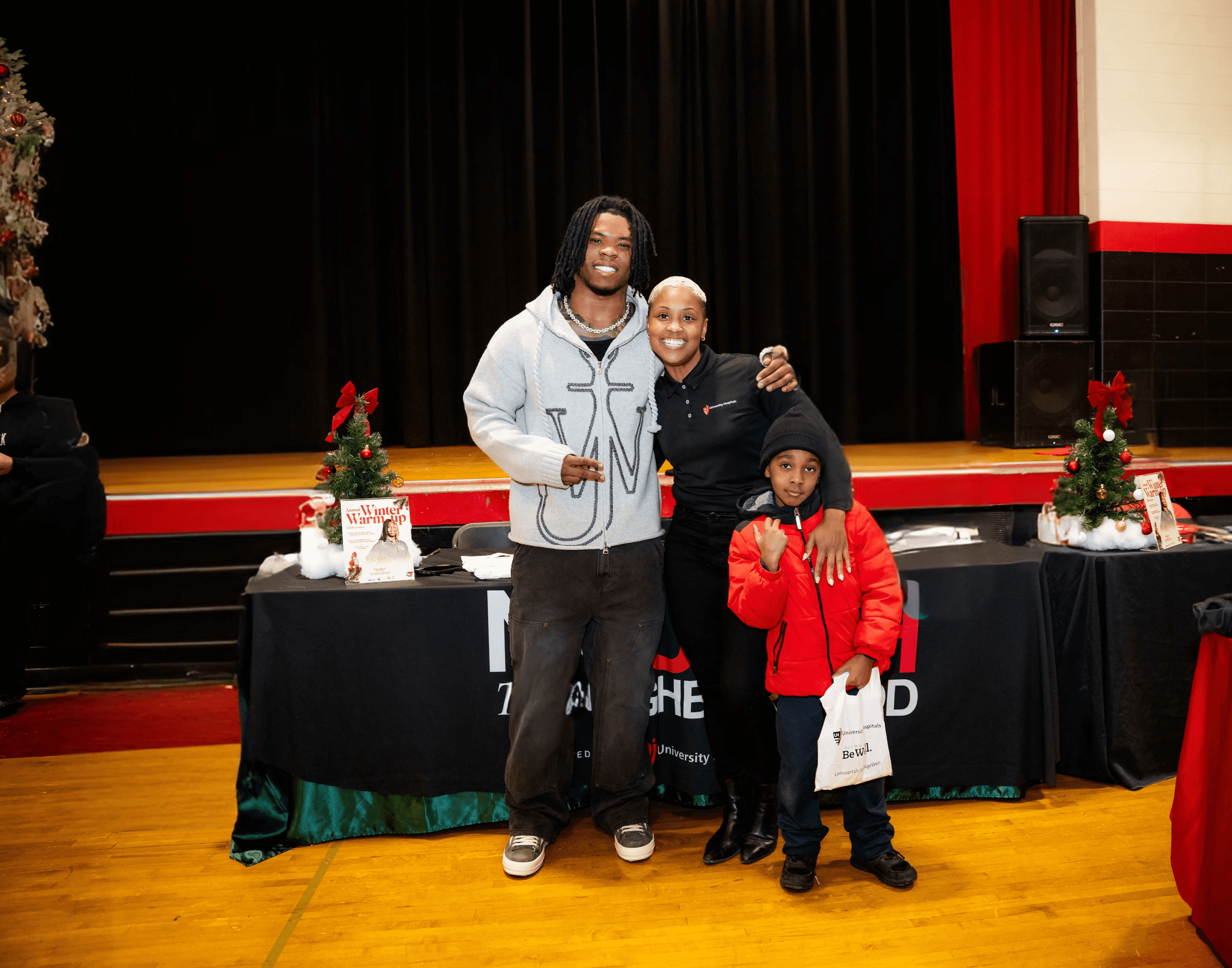 five children smiling while doing peace hand sign