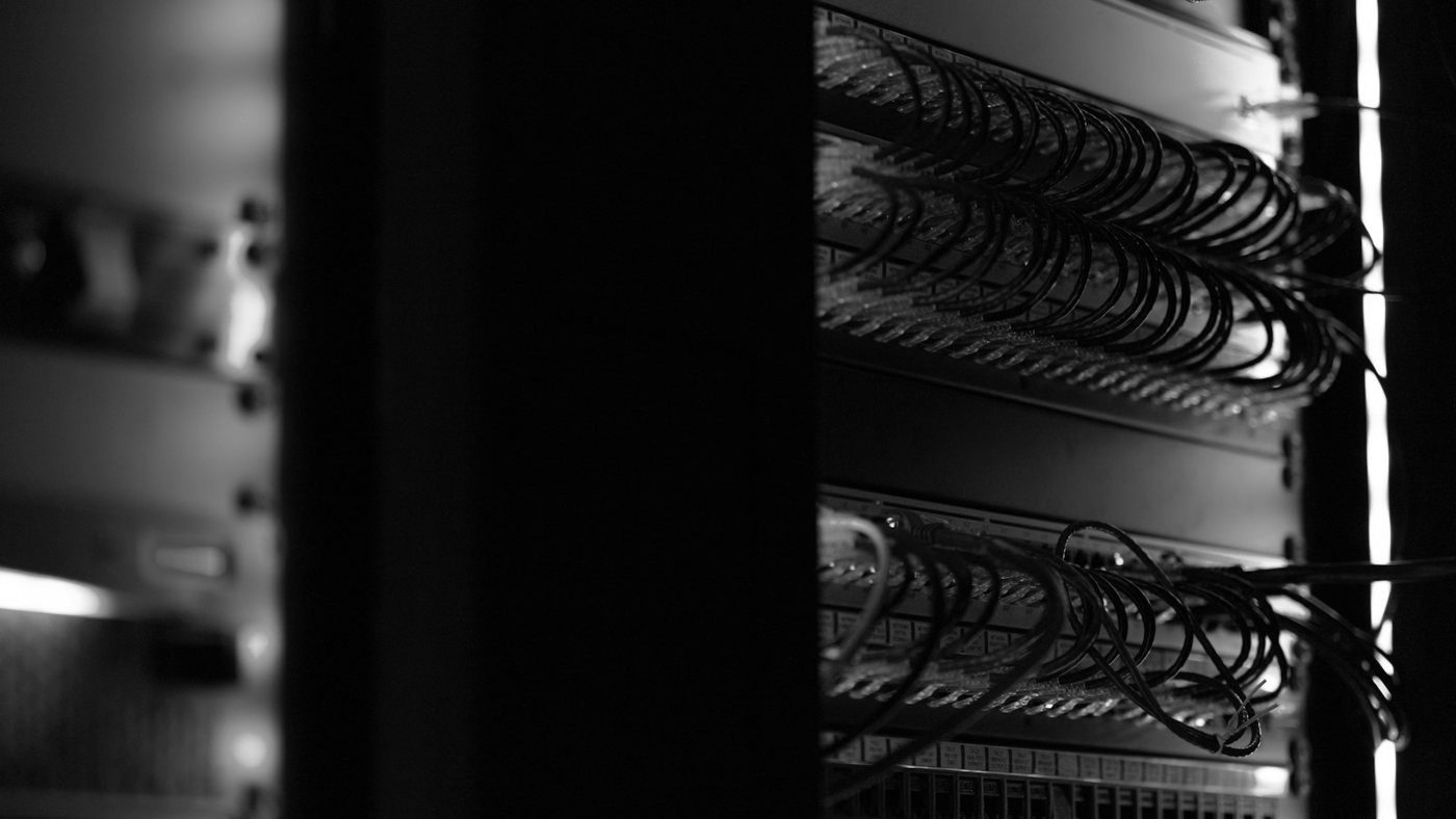 Server racks and cabling in a dark data room