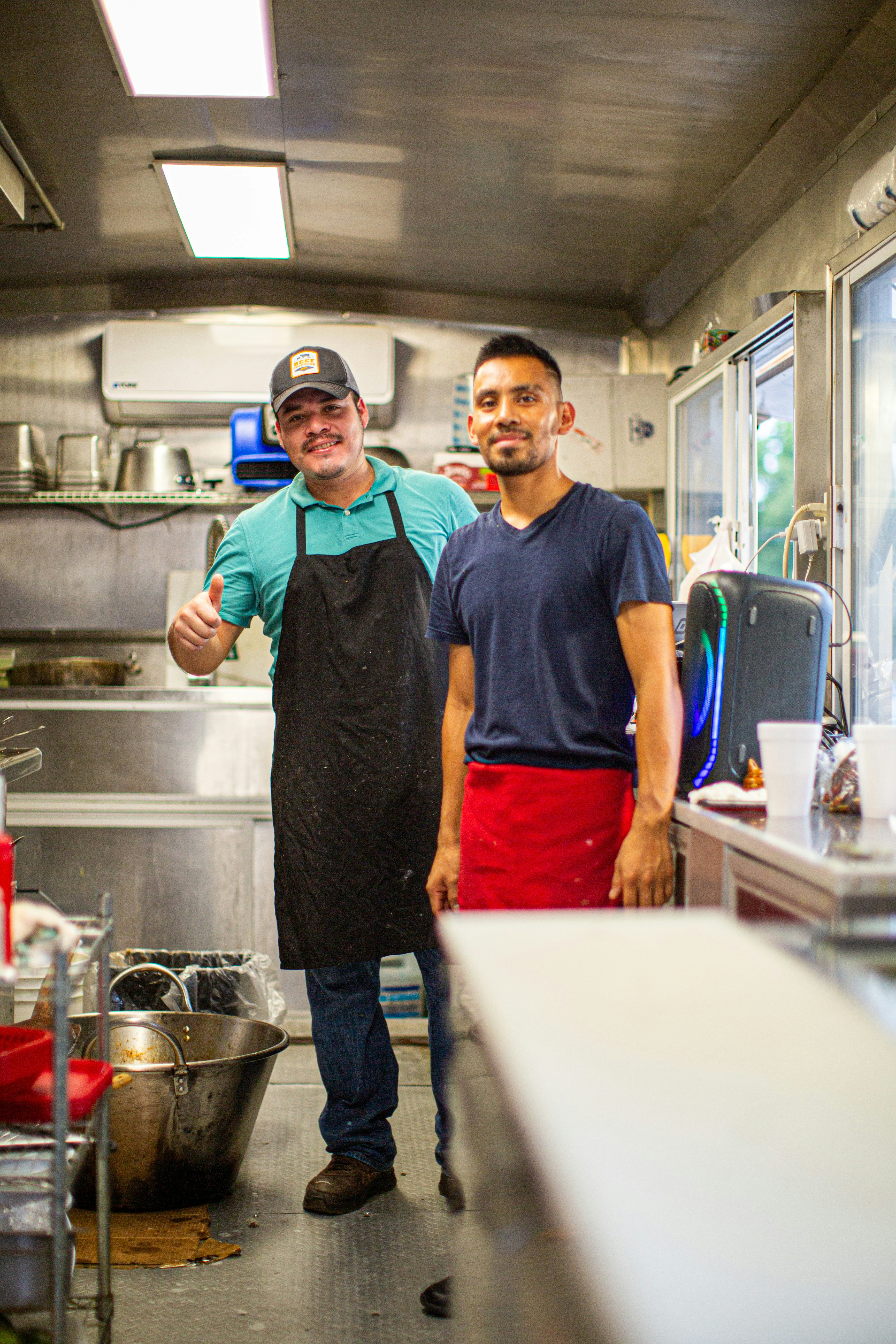 A couple of men standing in a kitchen next to each other