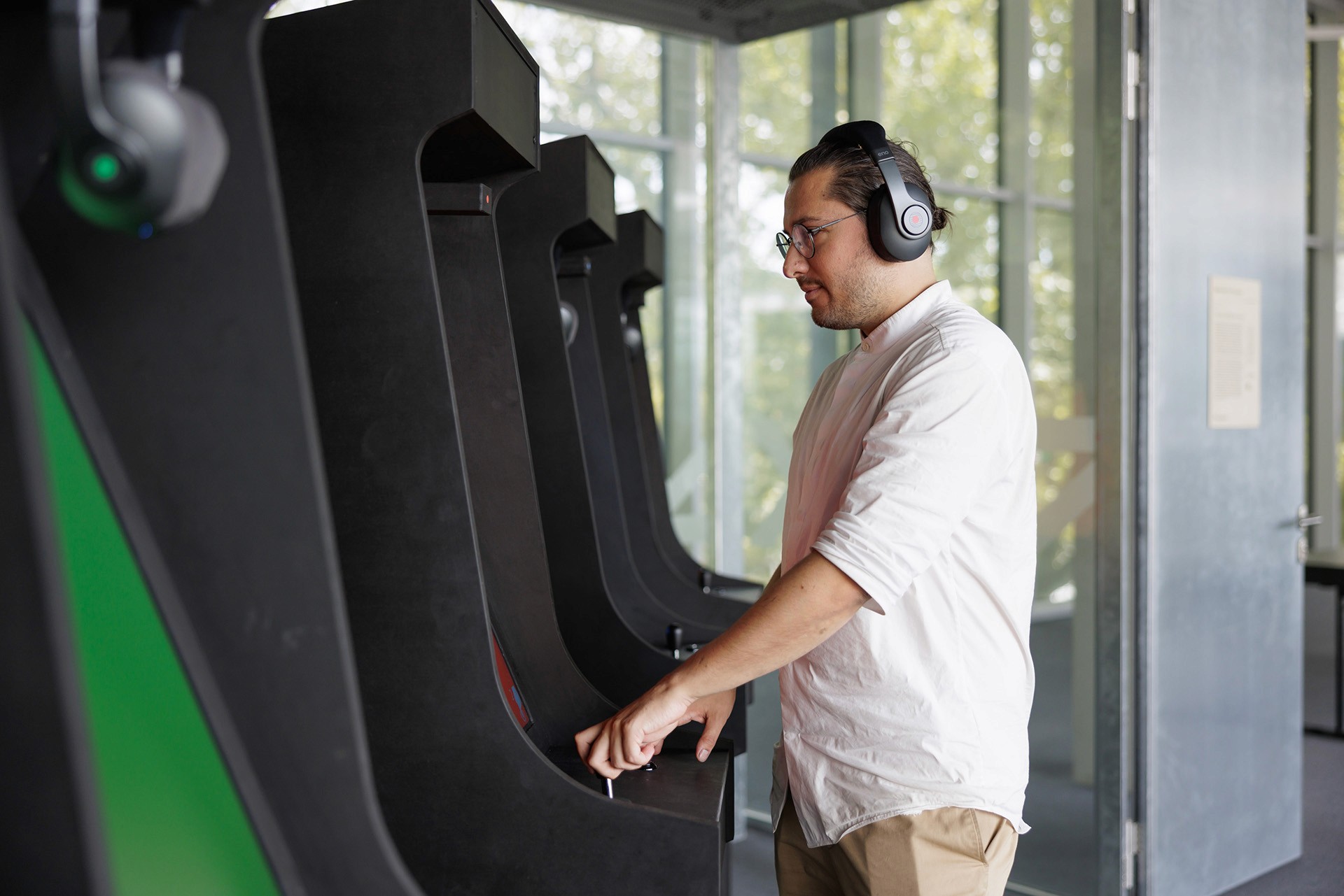 Man playing an arcade game with headphones.