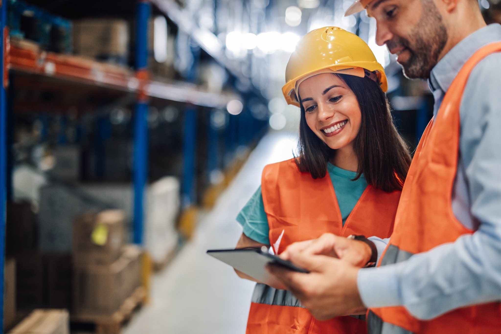 Warehouse worker using a laptop to manage parcel tracking and logistics in a distribution center