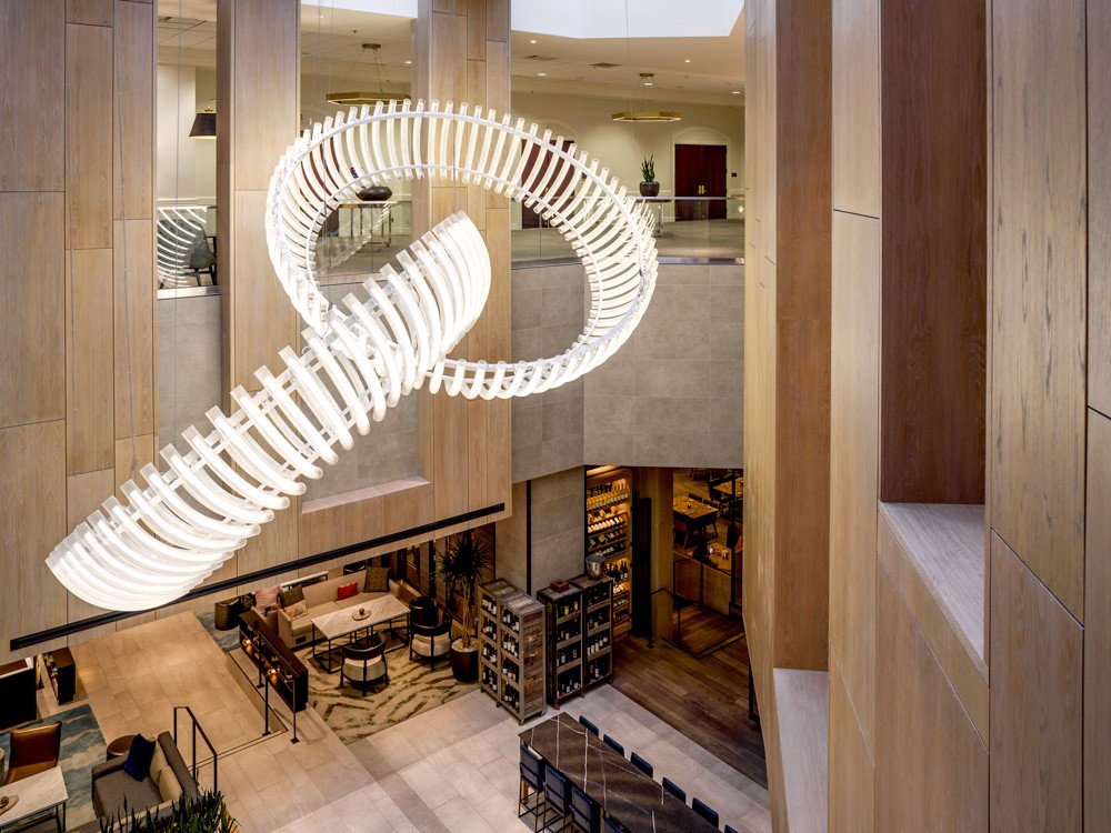 Side perspective of Finale installation, illustrating the precise engineering and suspended arrangement of fluted glass elements.