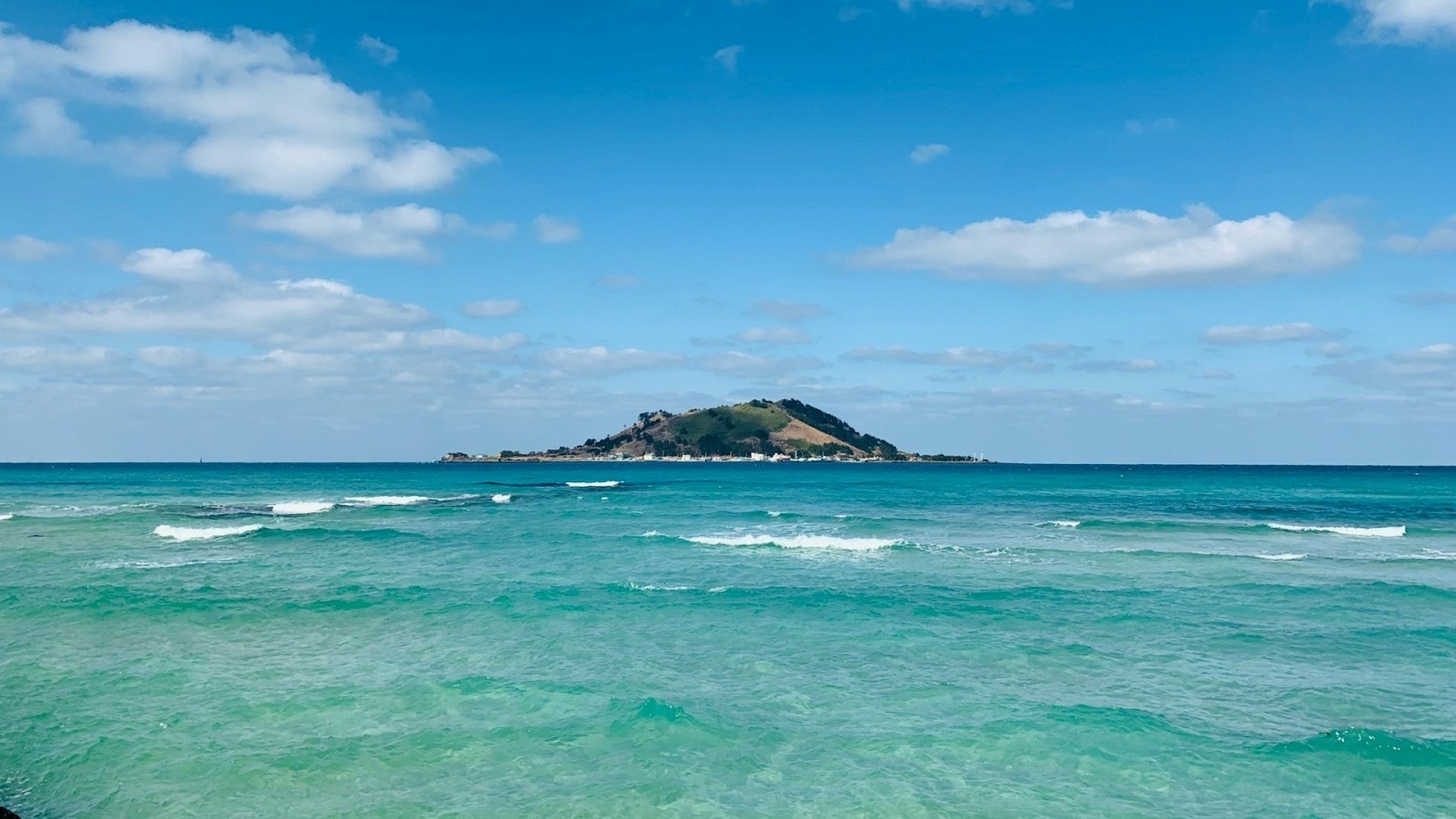 three brown wooden boat on blue lake water taken at daytime