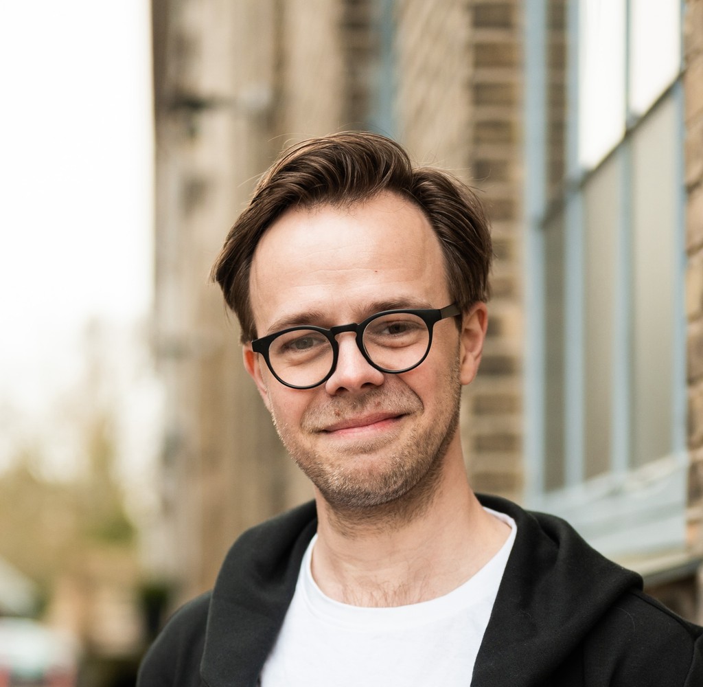 A portrait of a young man smiling